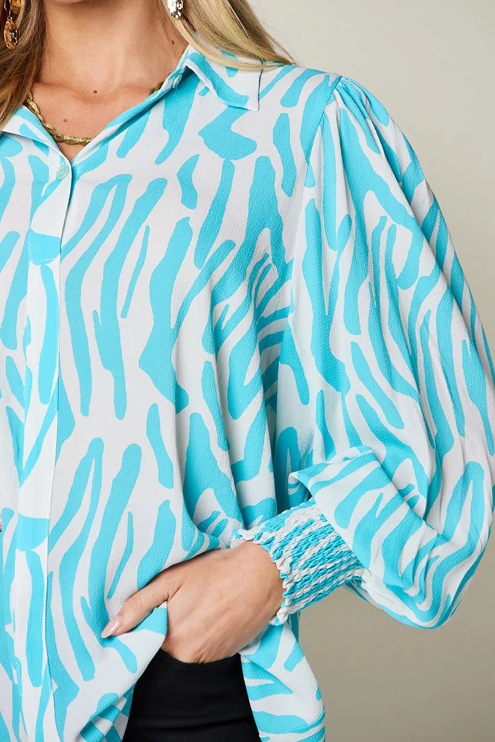 Seated view of the printed smocked blouse