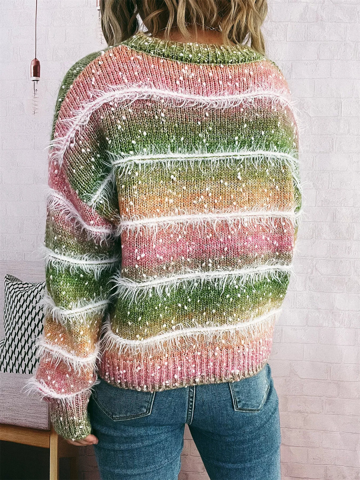 gradient striped round neck sweater worn with denim