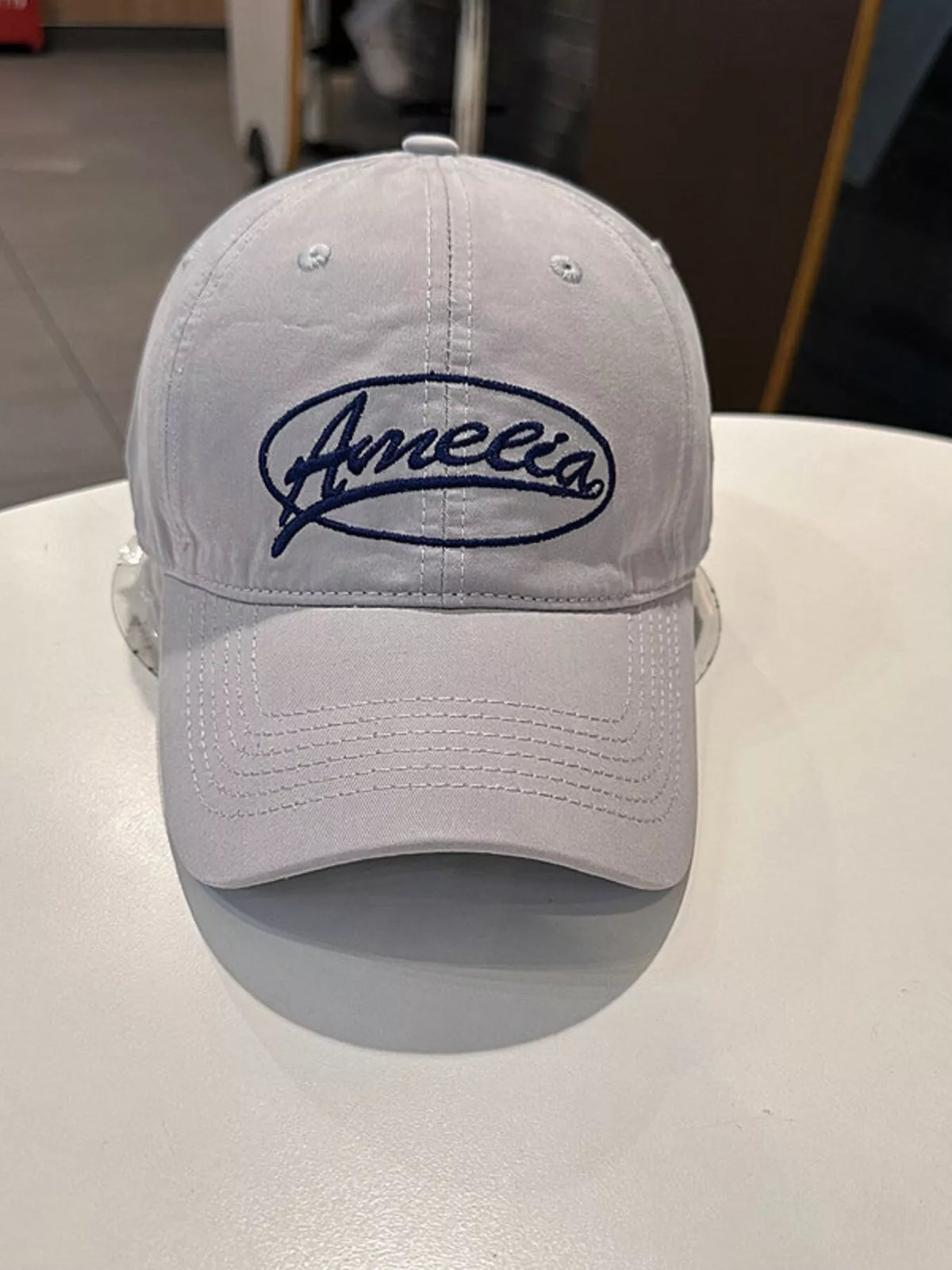 The embroidered cap shown in a soft pastel colorway
