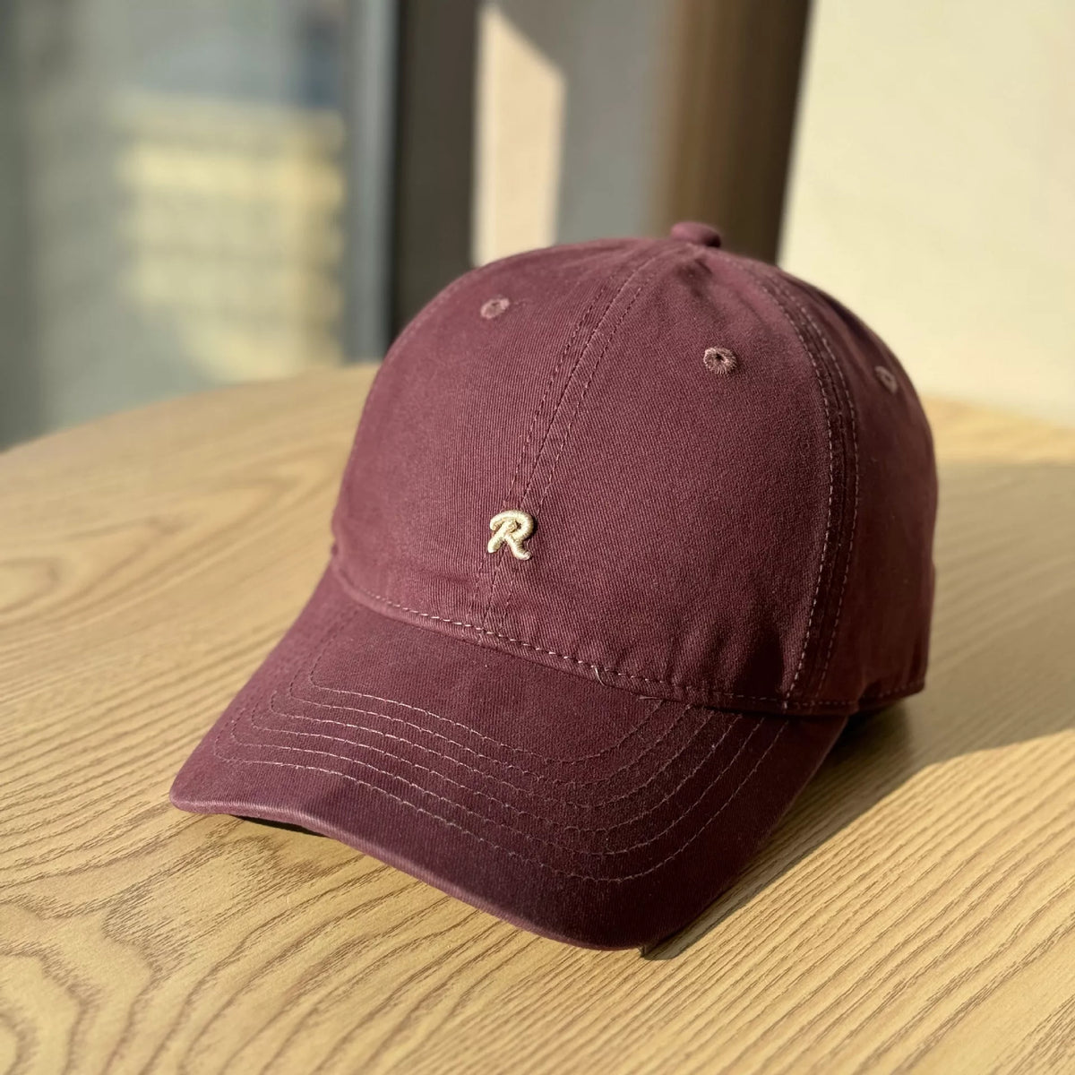 Embroidered cotton cap worn on model
