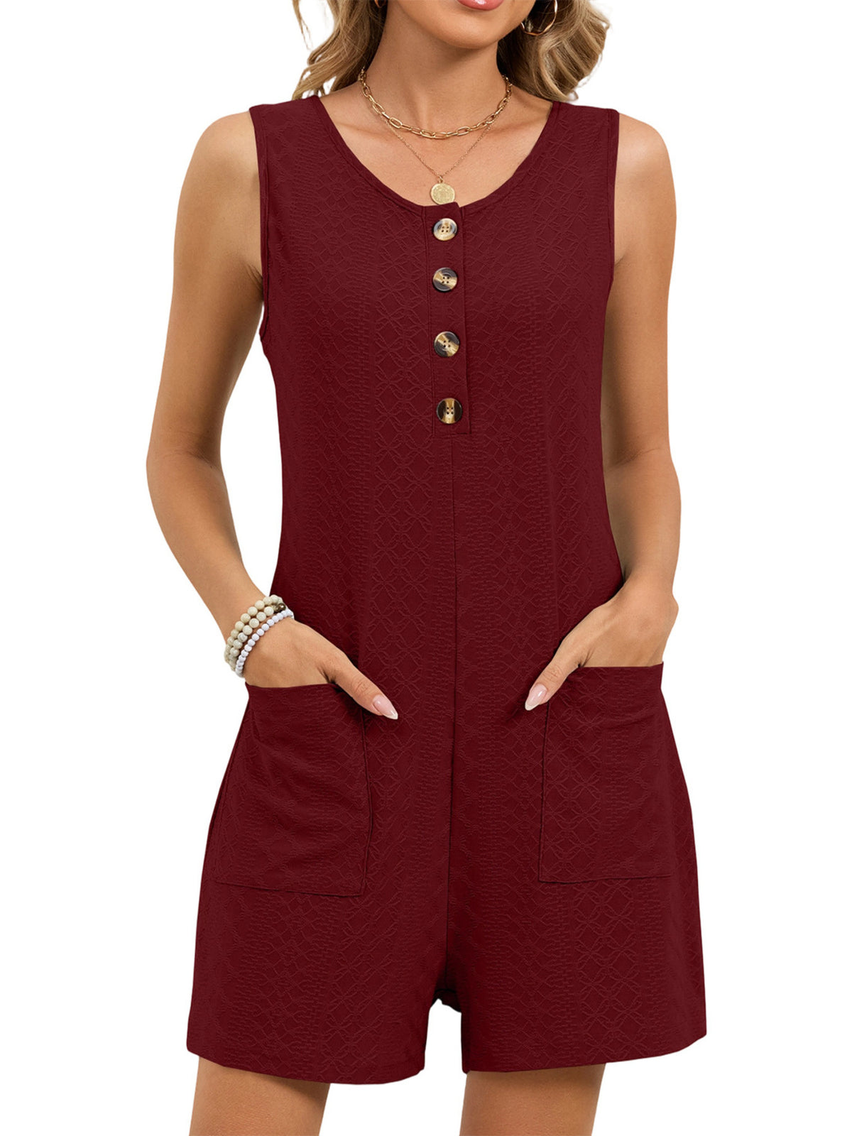Model wearing the button front sleeveless romper in a full length front view