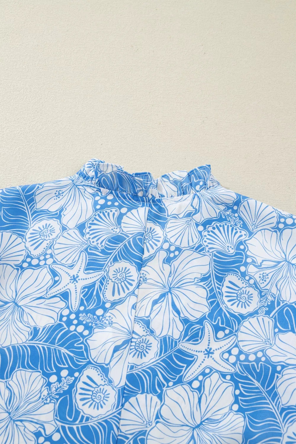Light blue floral scalloped trim v neck blouse close up view