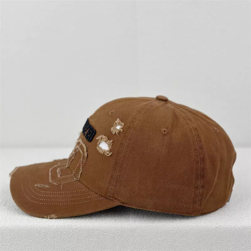 Side profile of the distressed cap showing the curved brim