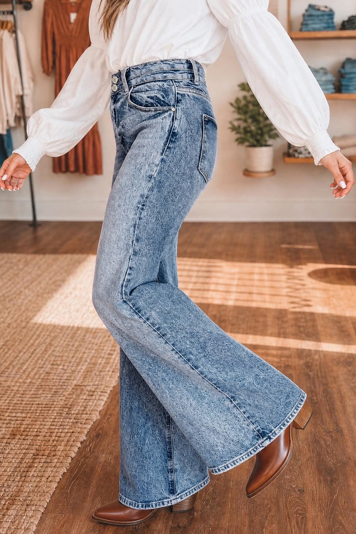Side view of blue acid wash high waist flare jeans