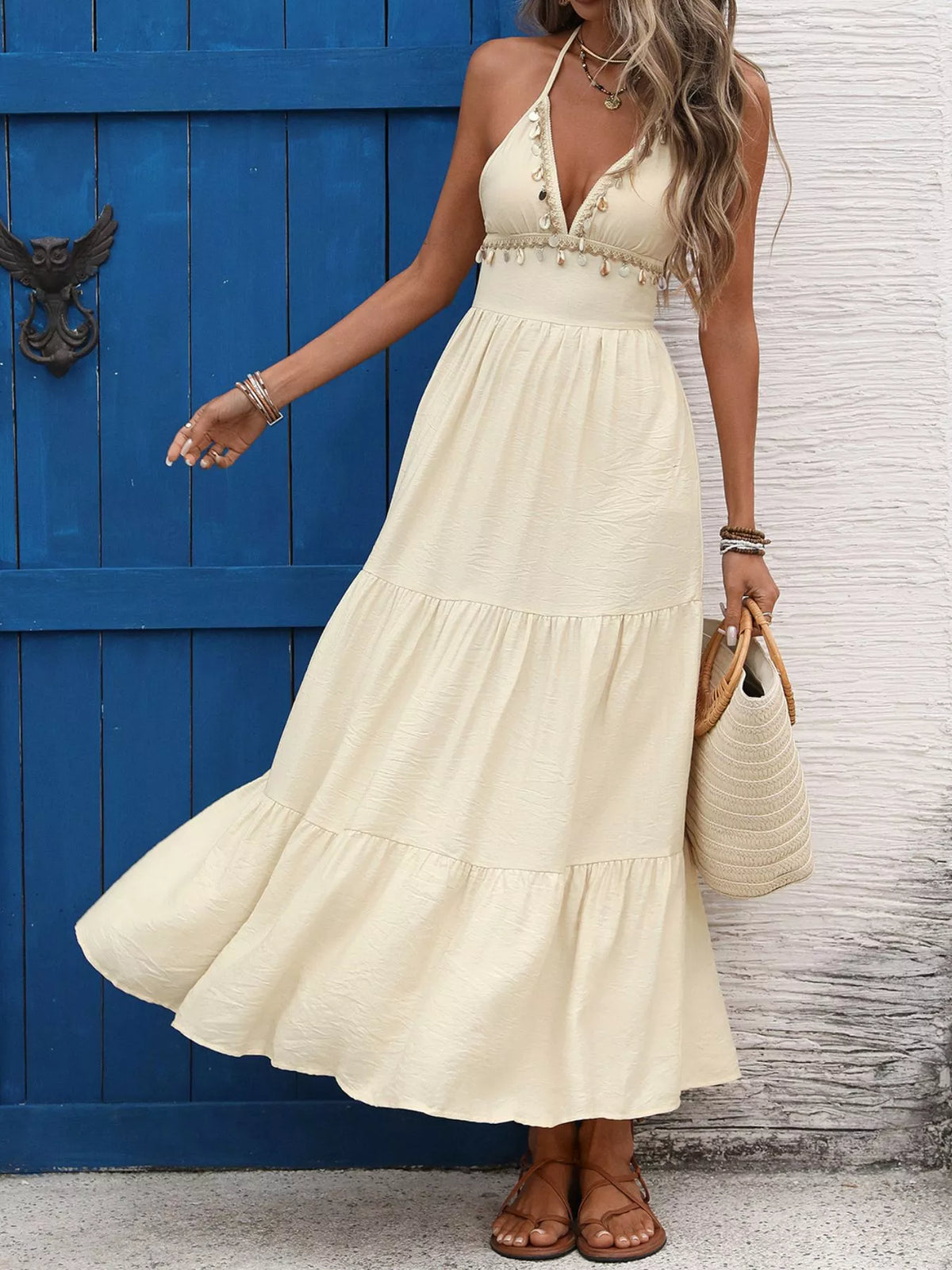 Pastel yellow halter neck tiered maxi dress detail of the hem