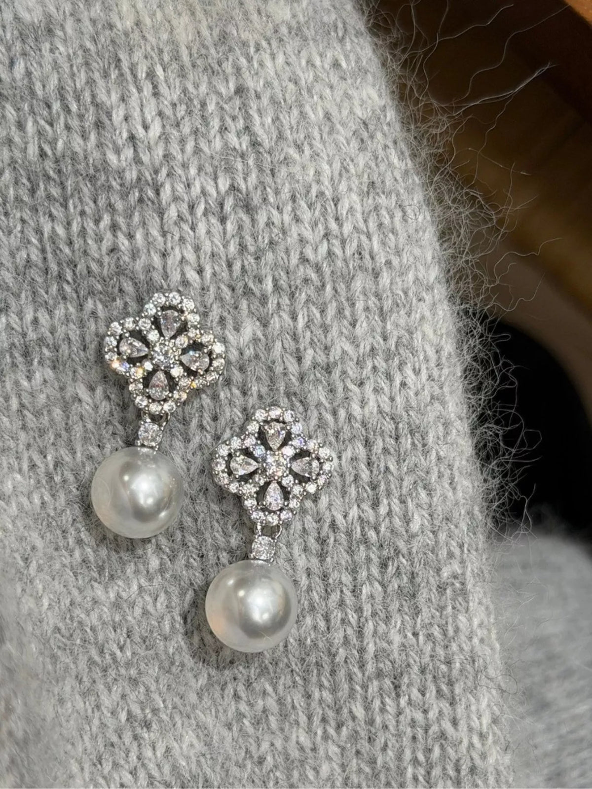 Four leaf clover pearl earrings close up