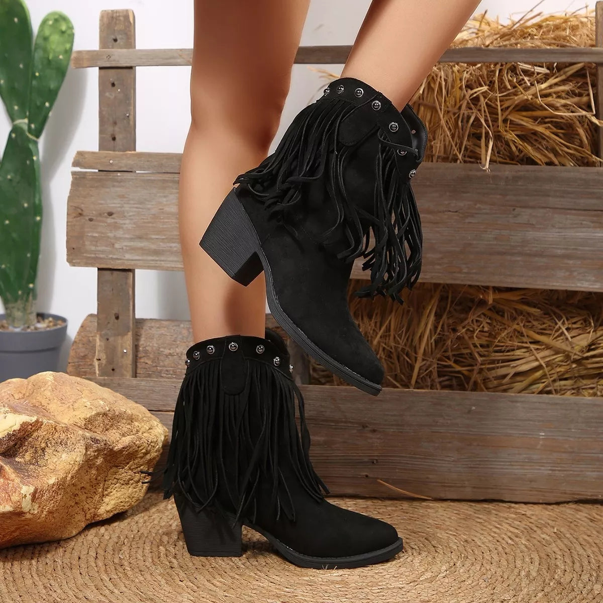 Fringed point toe boots angled pair