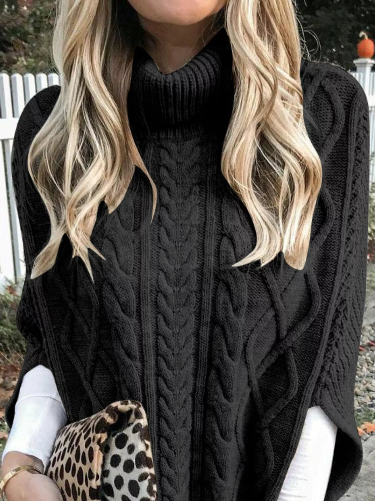 Chunky cable knit turtleneck poncho fabric texture close up
