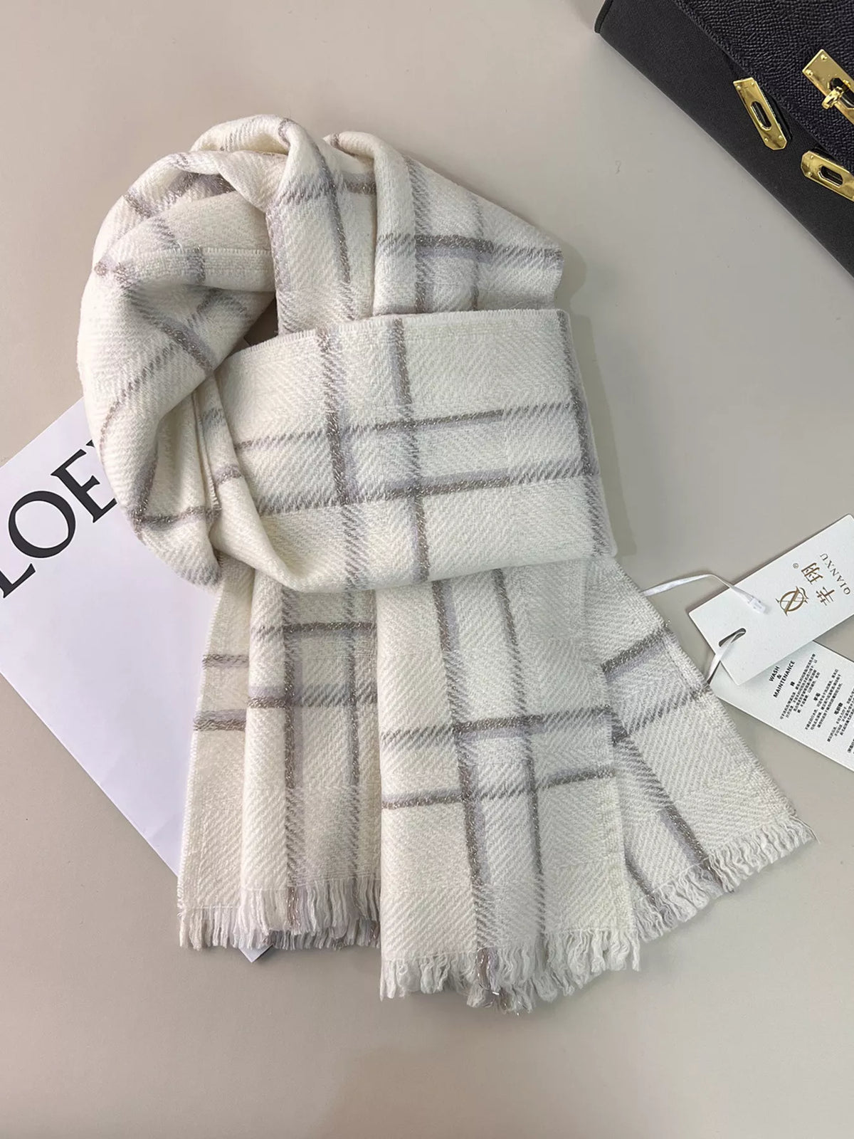 Wool plaid scarf with raw hem shown at full length