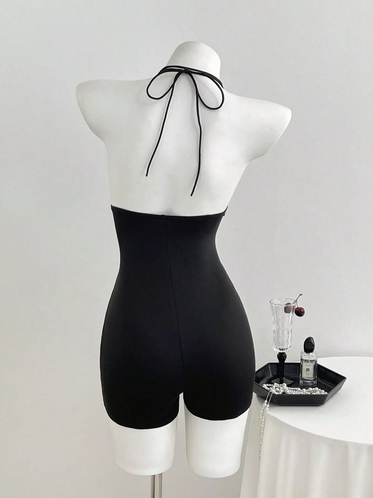 Black halter neck romper back view