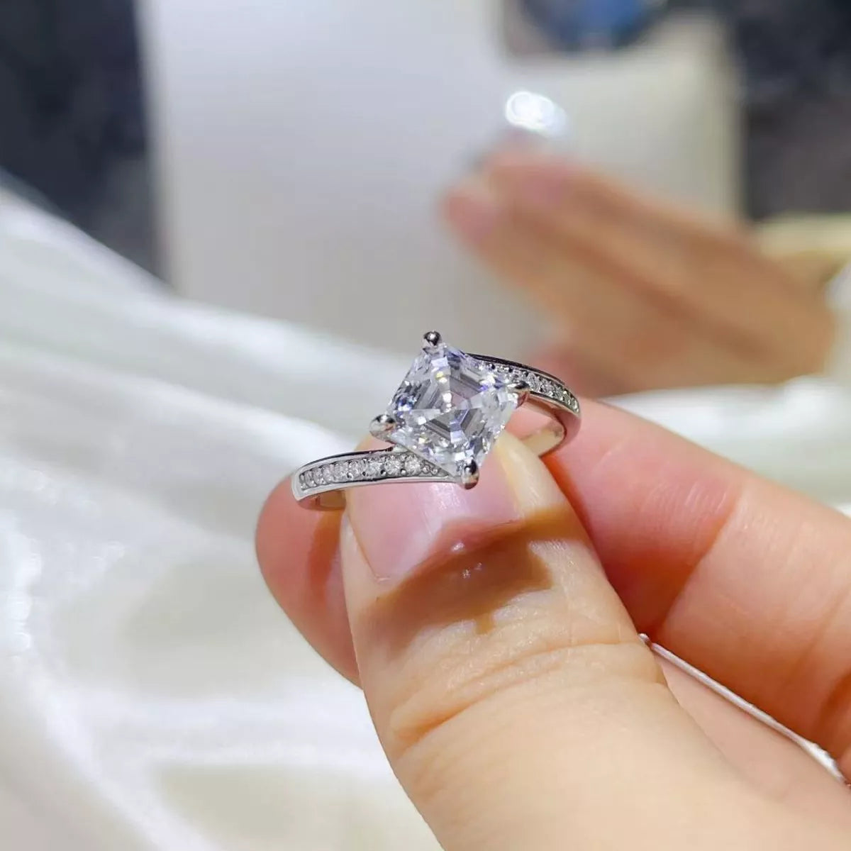 Close up of the clear moissanite stone and silver setting