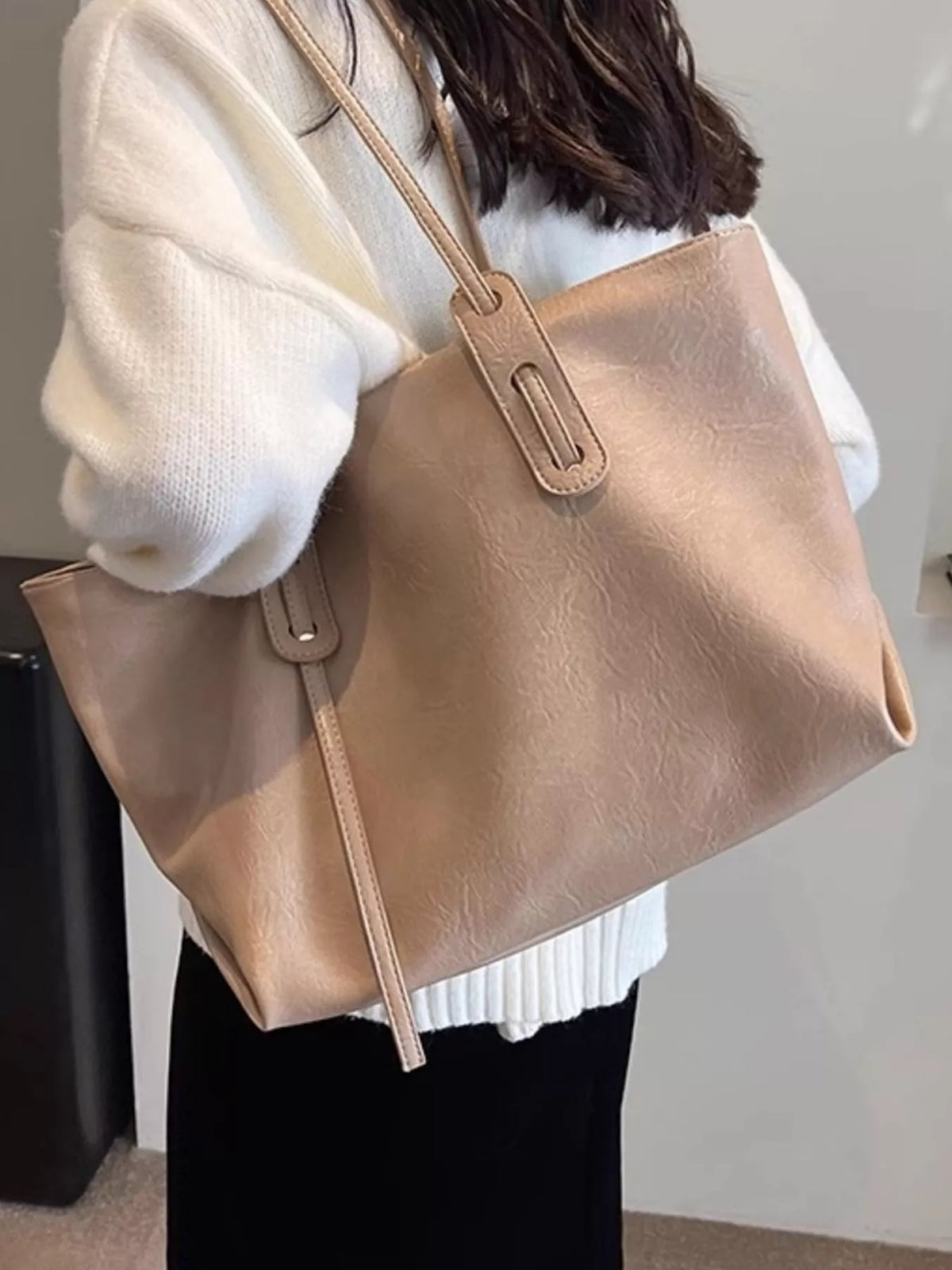 Strap detail on PU leather shoulder bag