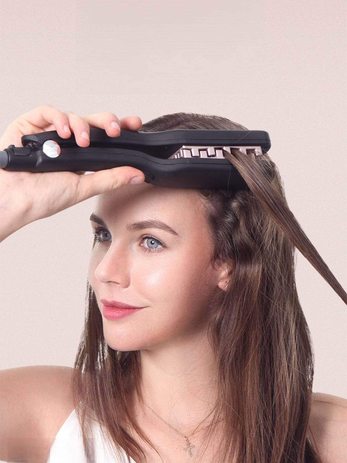 Hair straightener in use on hair