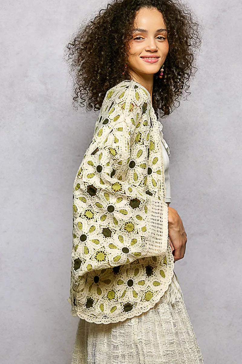 Close up of the green floral crochet knit pattern