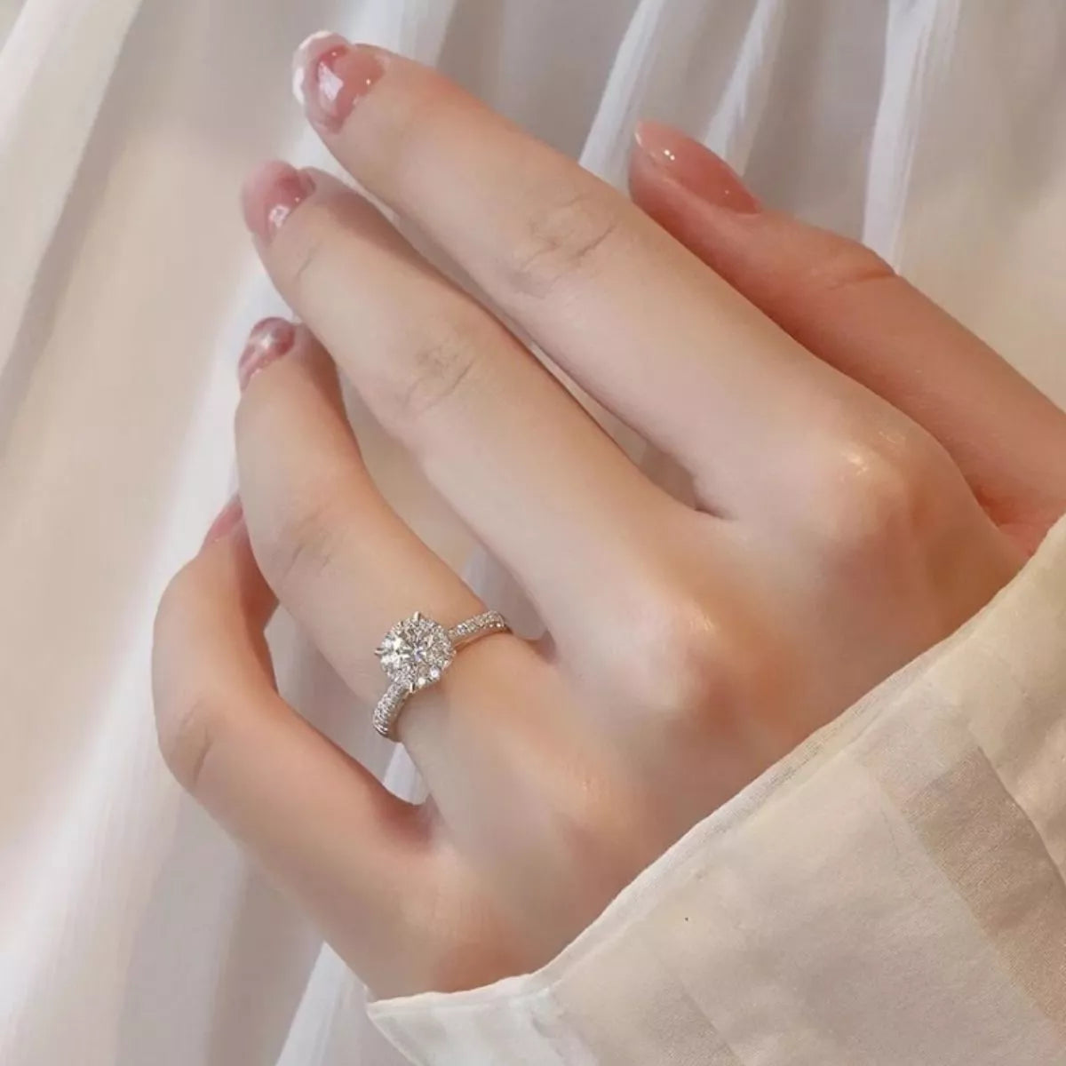 The moissanite ring shown worn on the hand