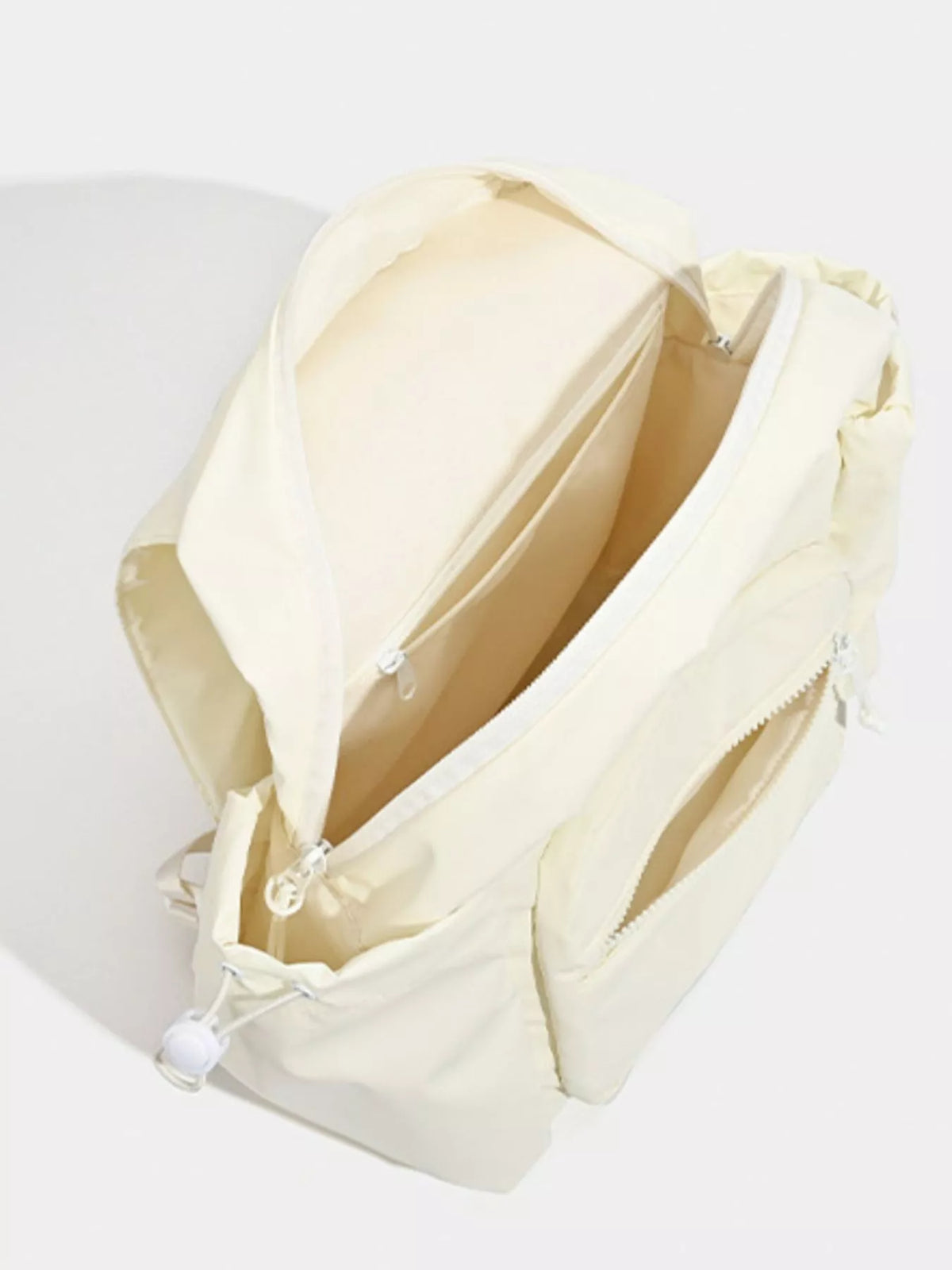 White canvas backpack side profile