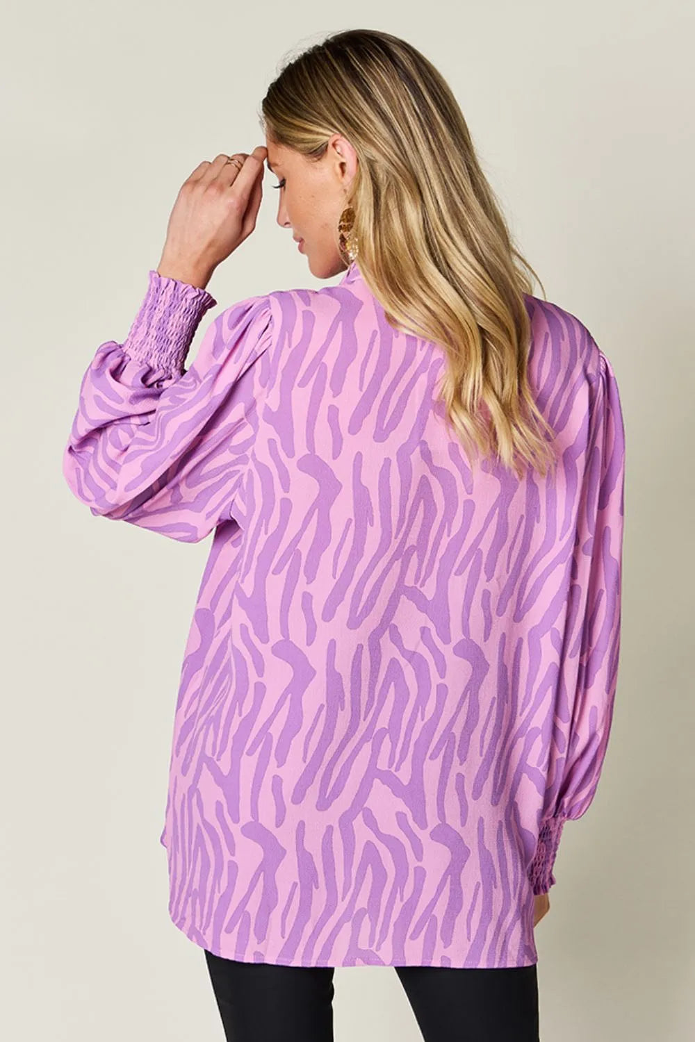 Smocked blouse shown on a standing model