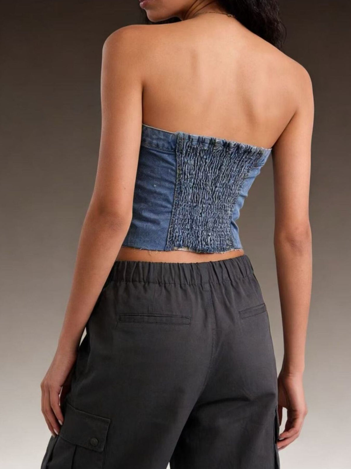 Close up of buttons and pocket on denim top