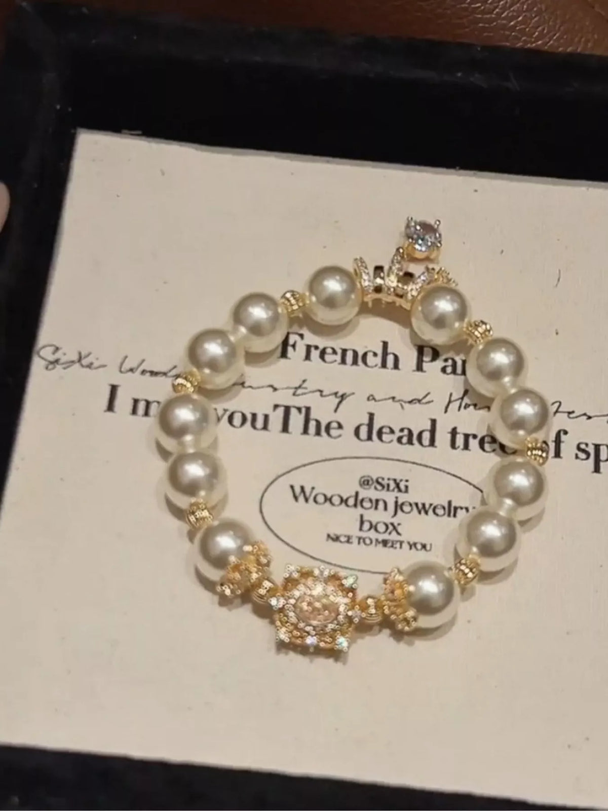 Gold pearl bracelet flat lay