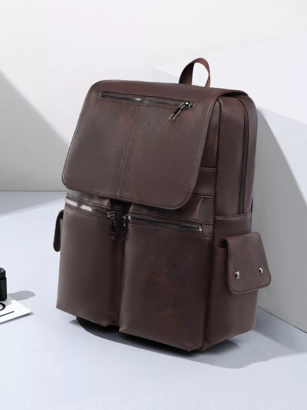 Faux leather flapover backpack interior compartment