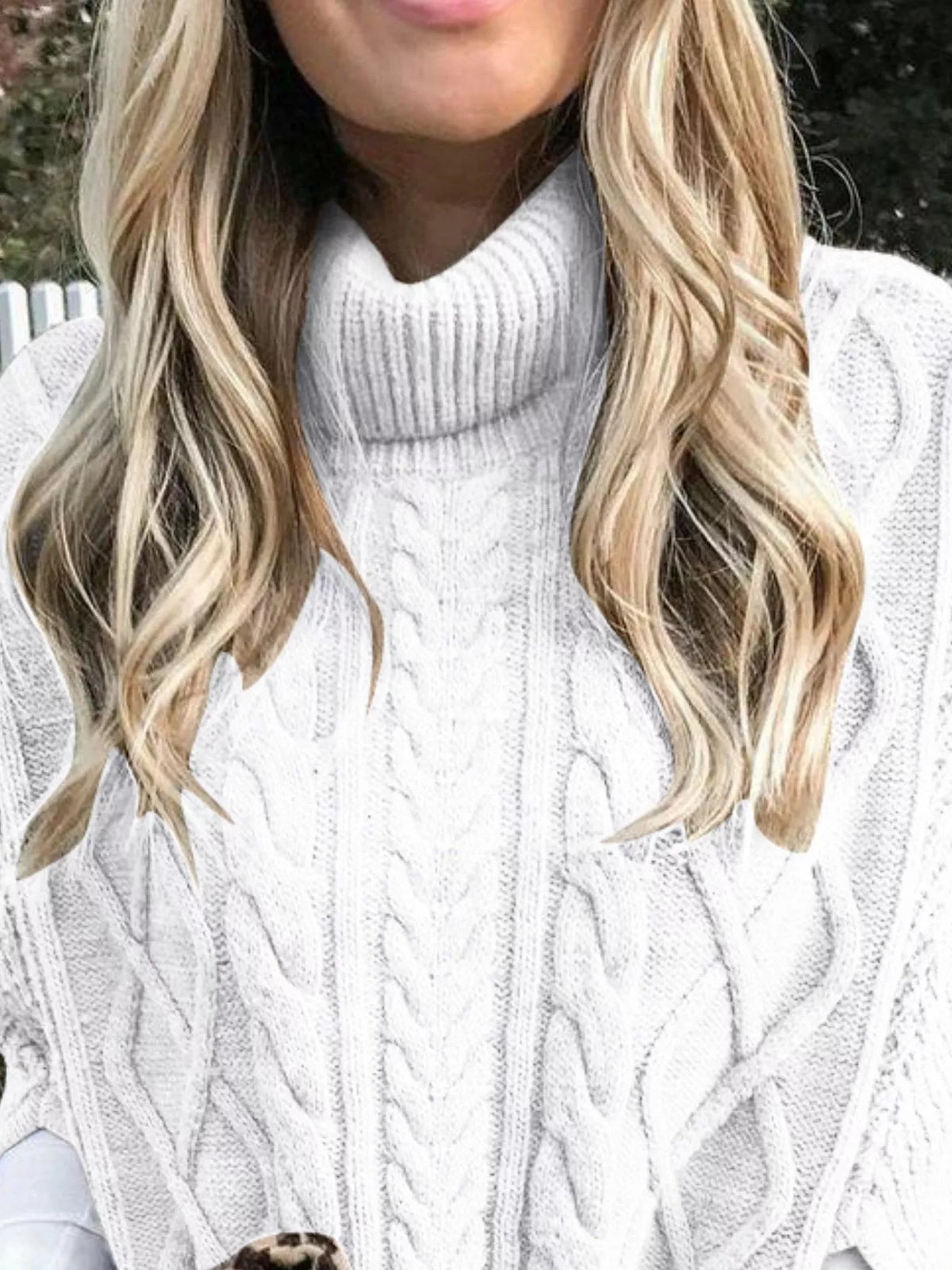 Chunky cable knit turtleneck poncho side view