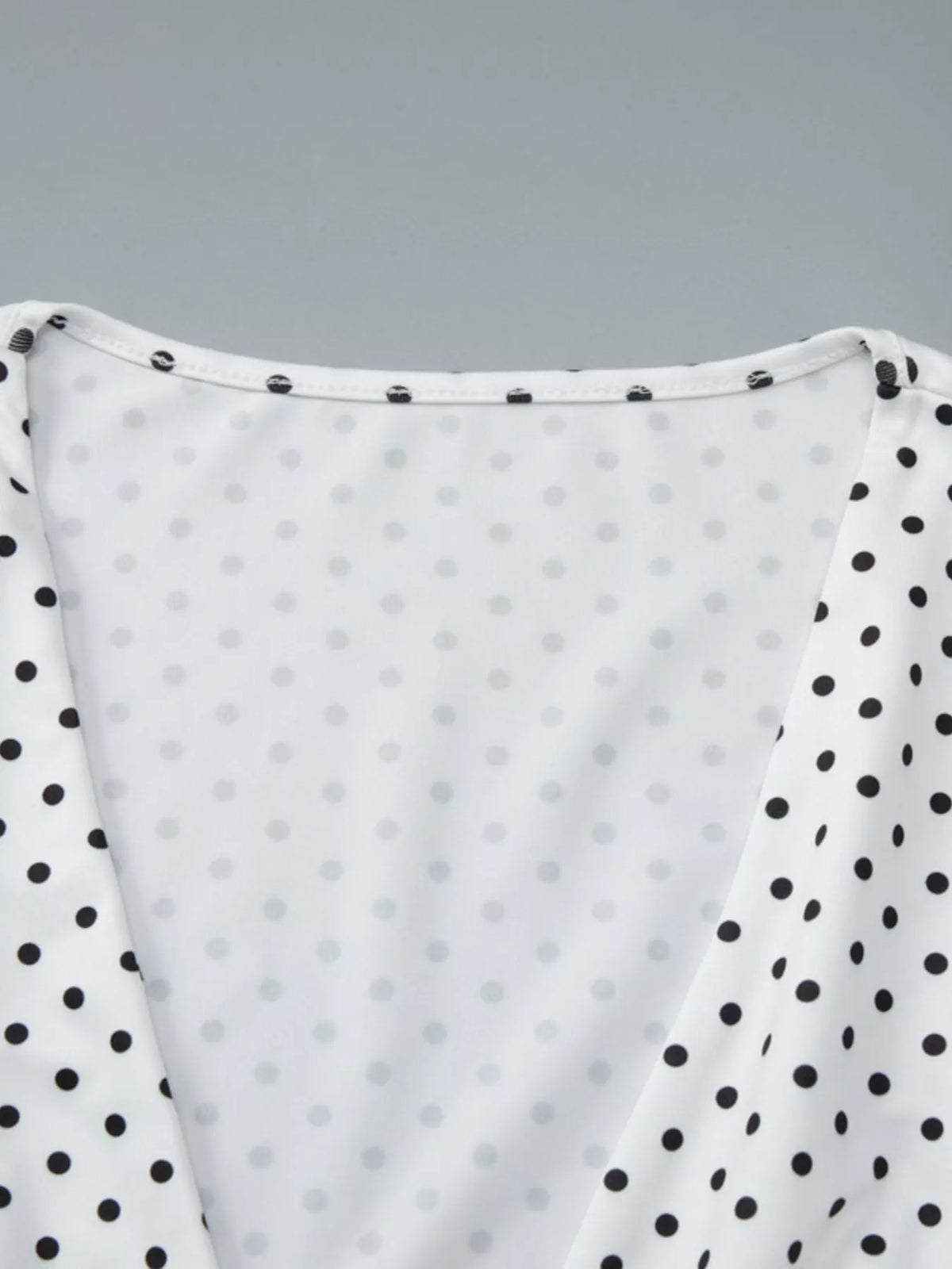 White ruched top shown with the V neckline in focus