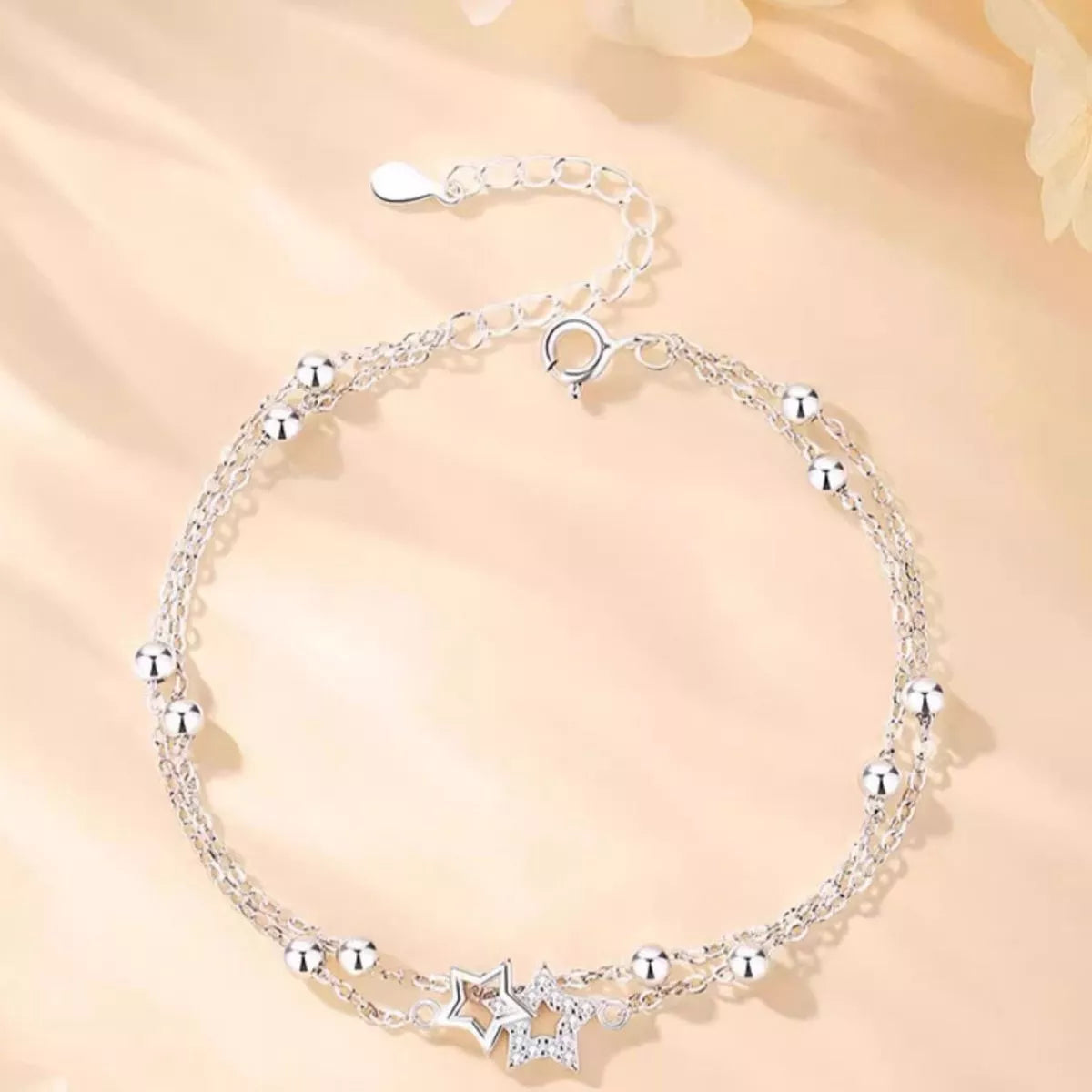 Close up of the zircon star charm on the silver chain