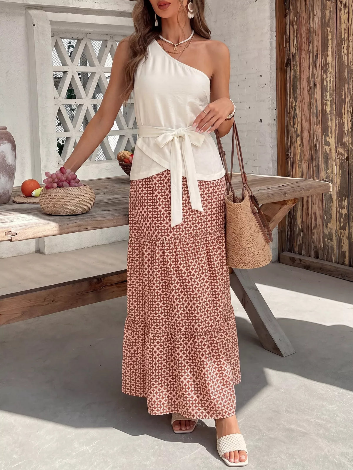 Cream coordinated one shoulder top and maxi skirt set detail