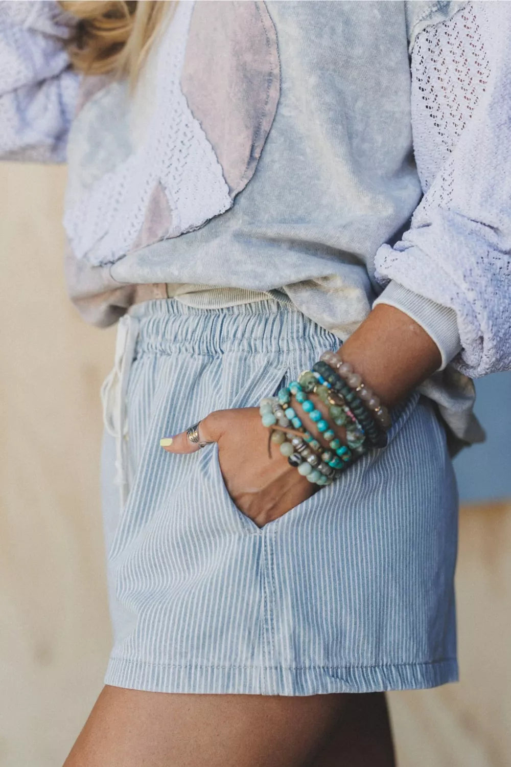 Light blue striped drawstring shorts styled outfit view