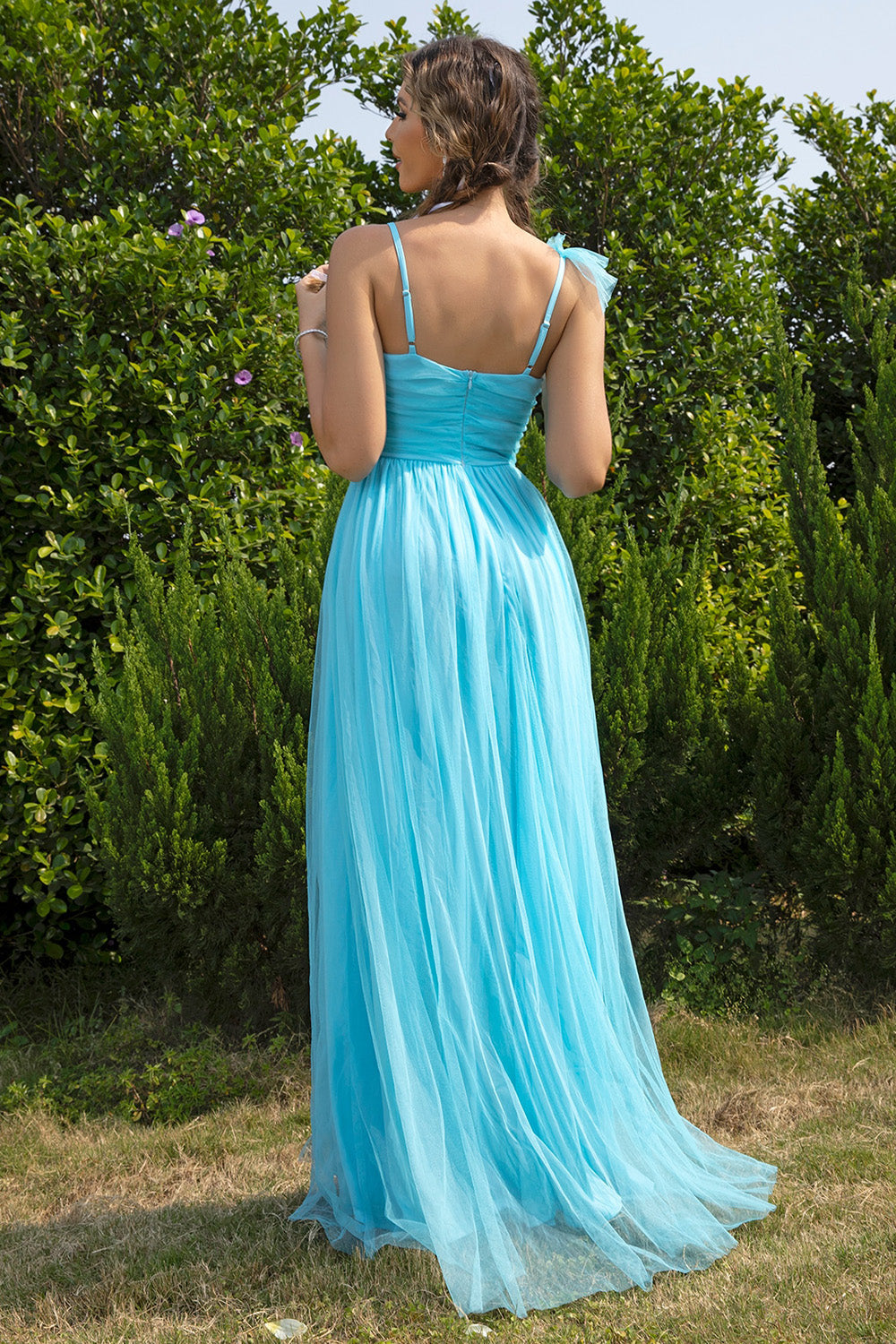 Ruched dress showing asymmetrical hem and slit
