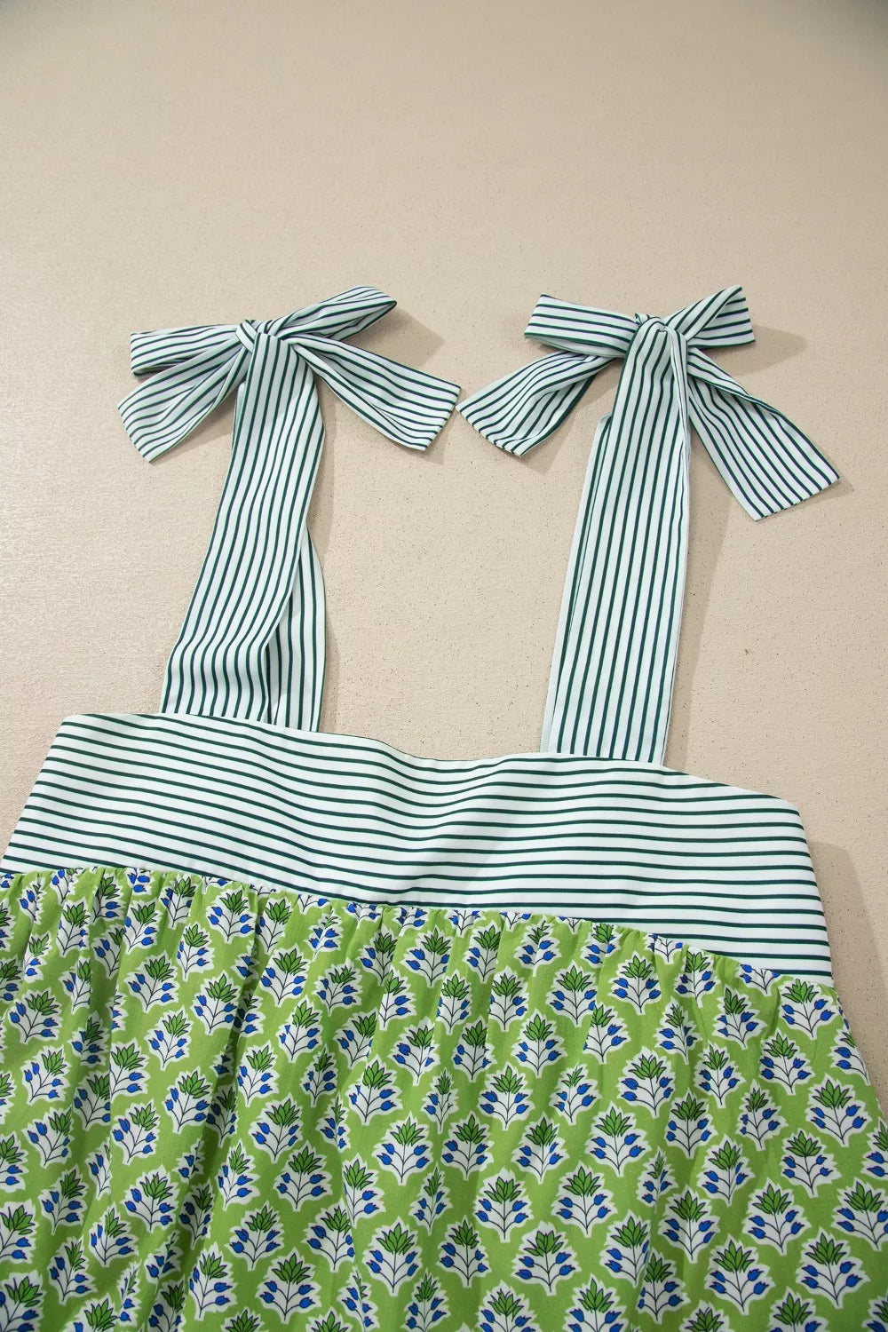 Matcha green floral print tie strap tank close up view