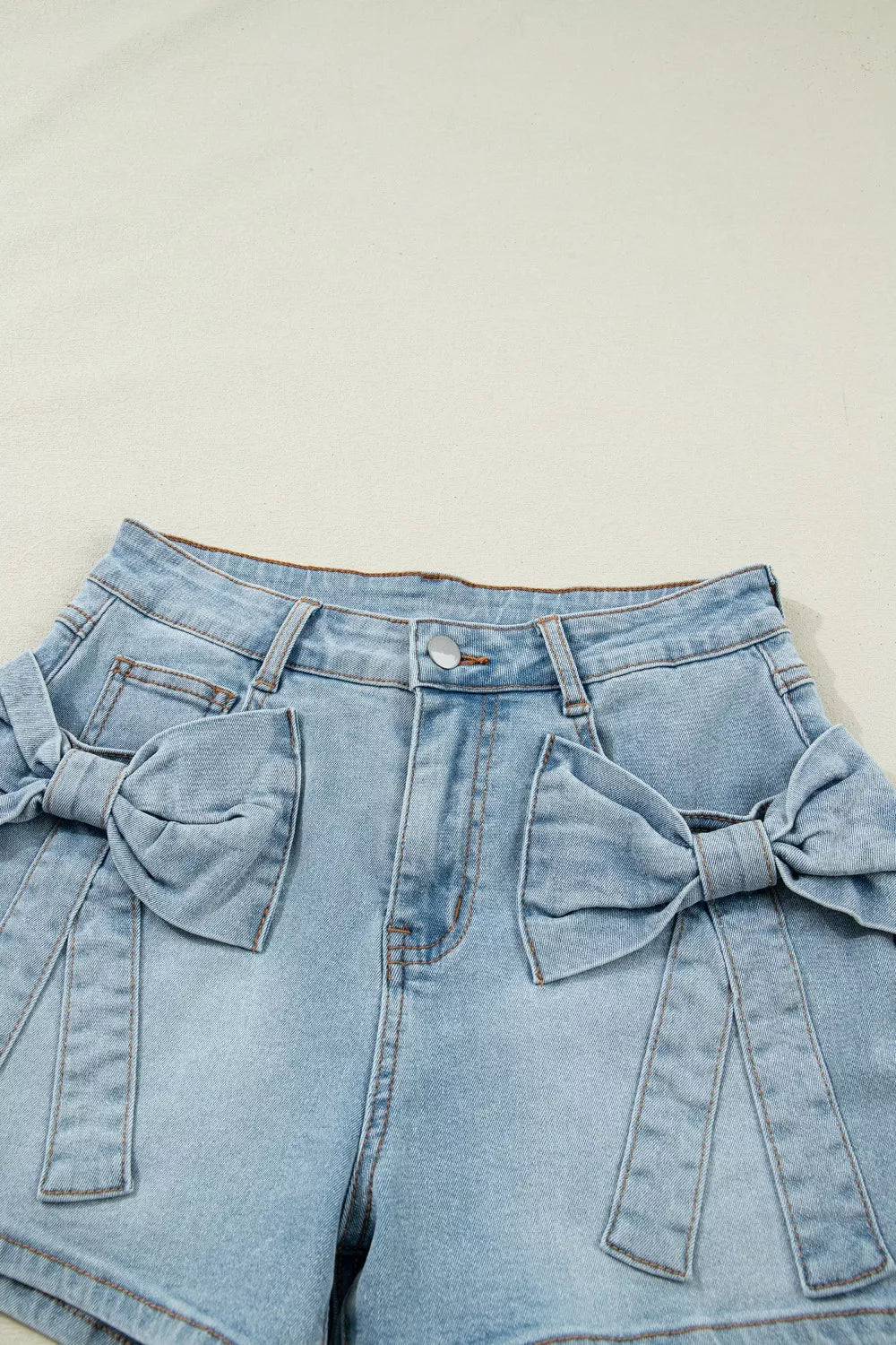 Light blue bow detail denim shorts styled view