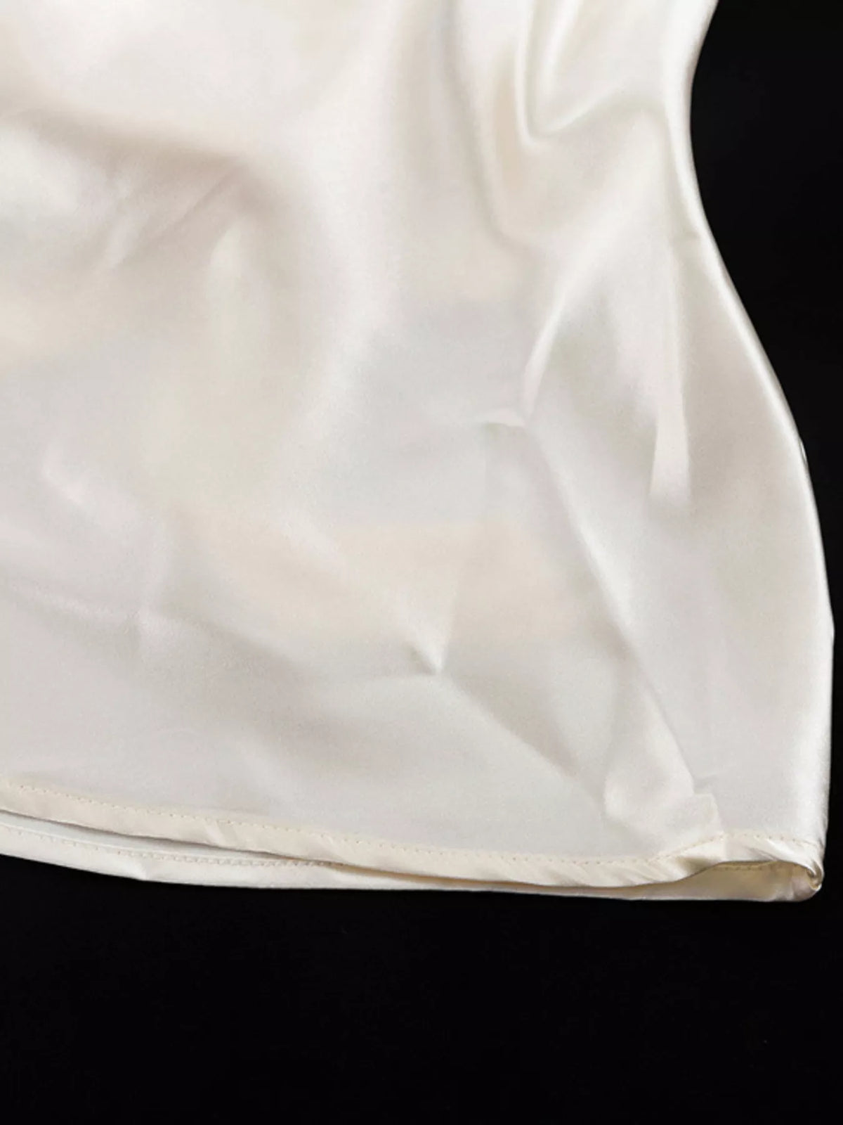 Waist and skirt drape on the beige satin dress
