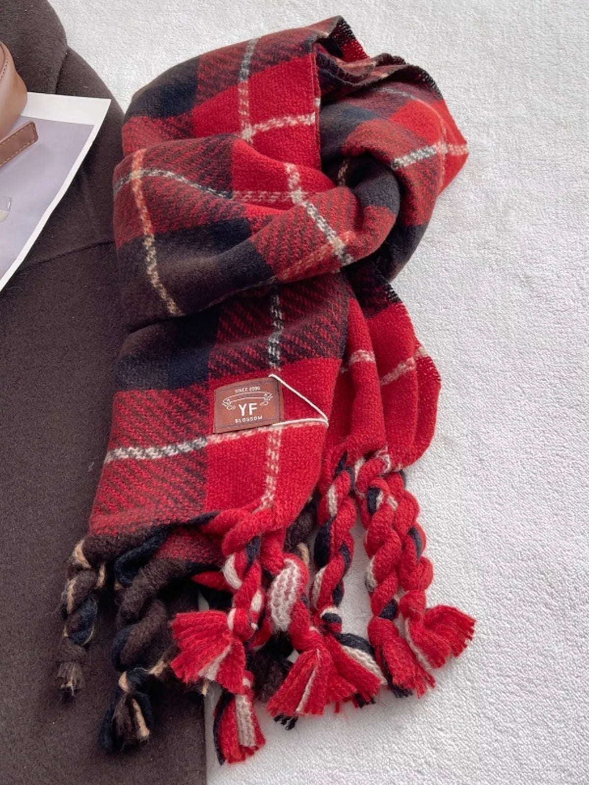 Close view of the plaid pattern on the tassel scarf