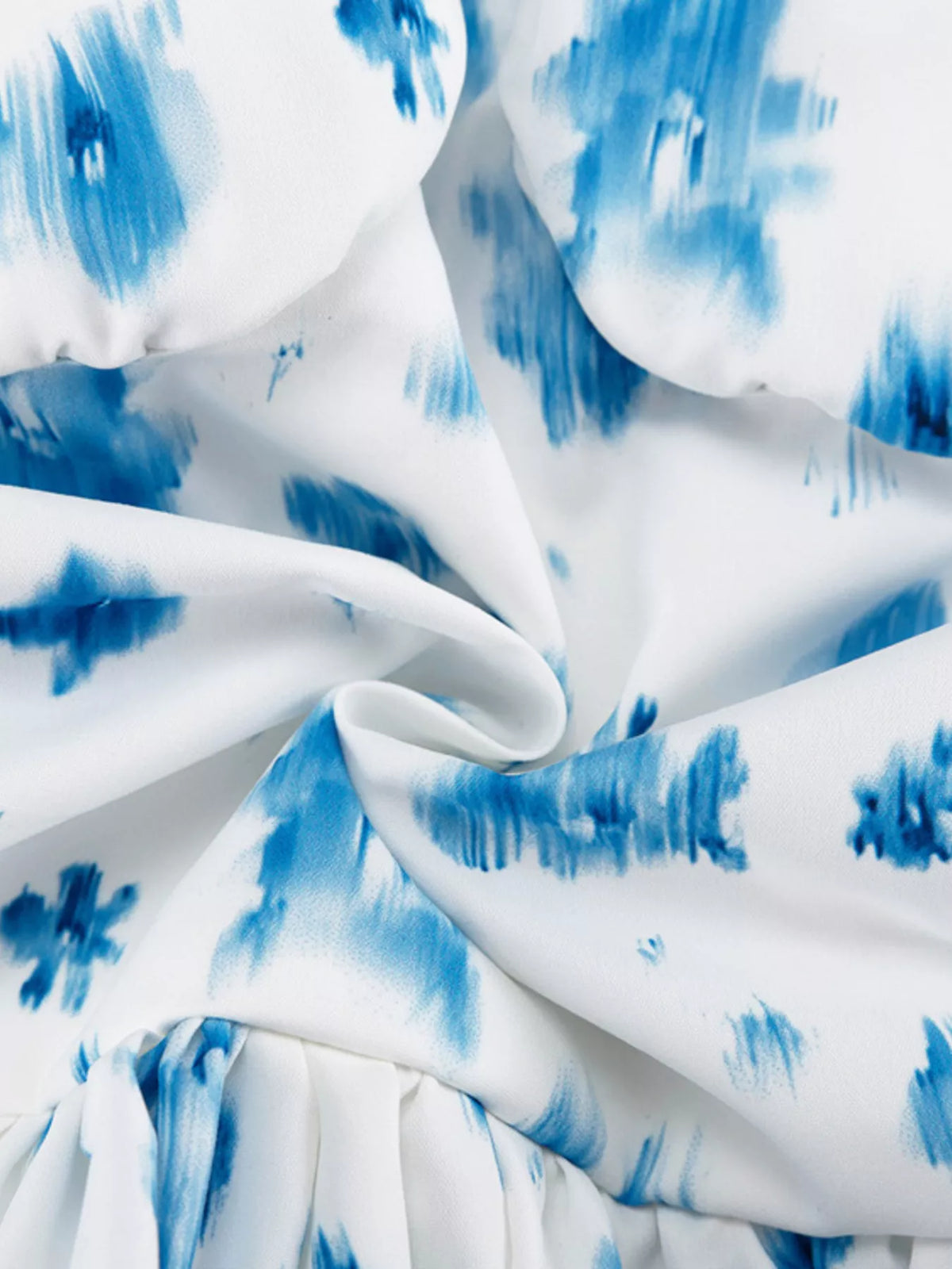 Floral print tank laid flat to show the shaped cut