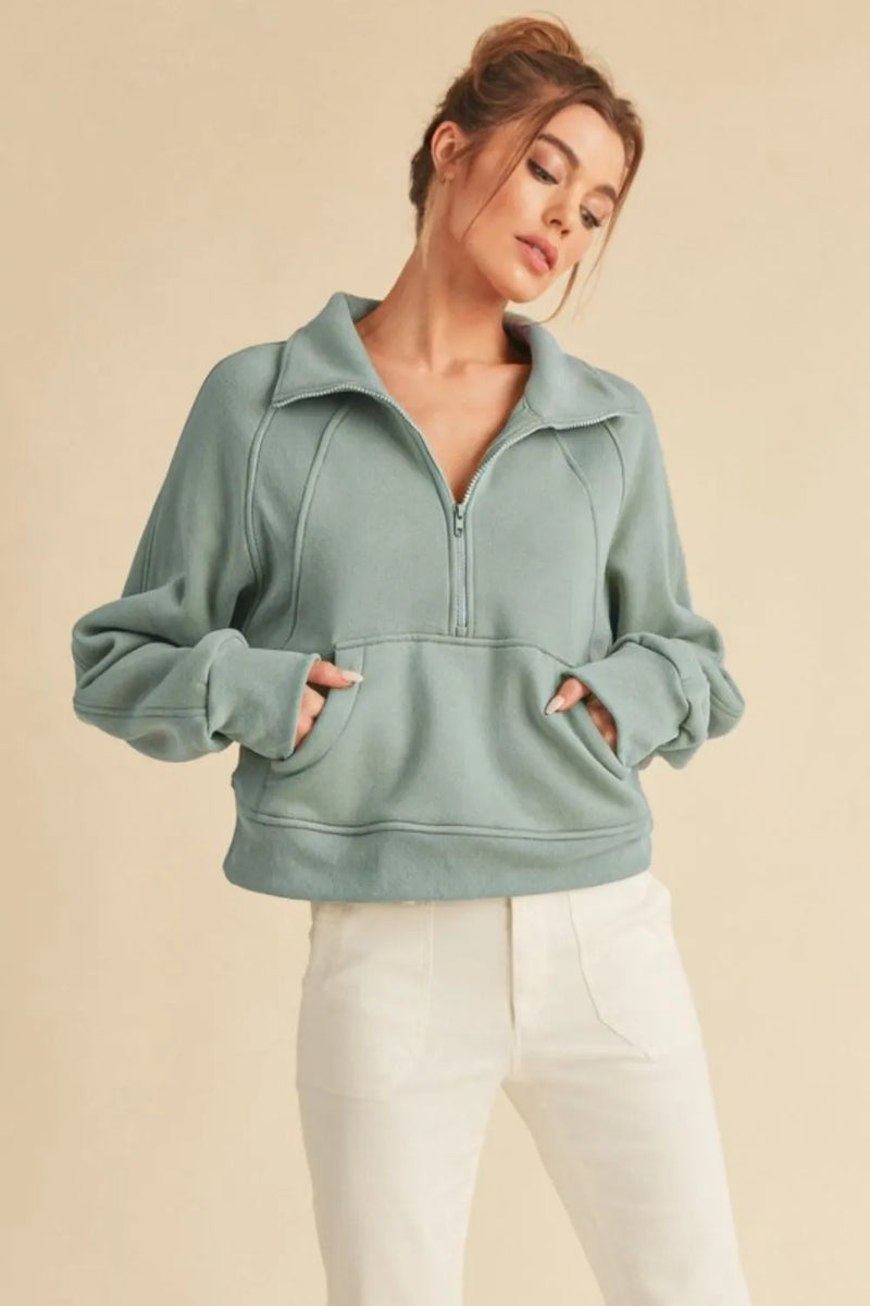 Pale blue half zip raglan sleeve sweatshirt front view