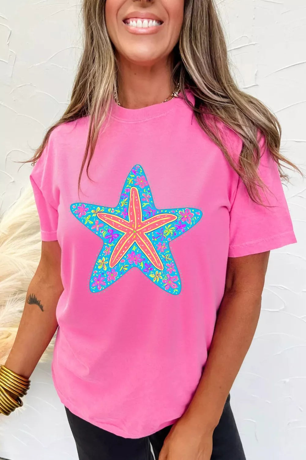 Fuchsia pink graphic tee styled on model, side angle