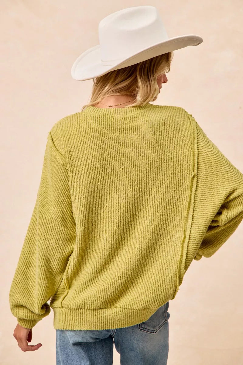 Lime green boucle uneven hem sweater detail shot