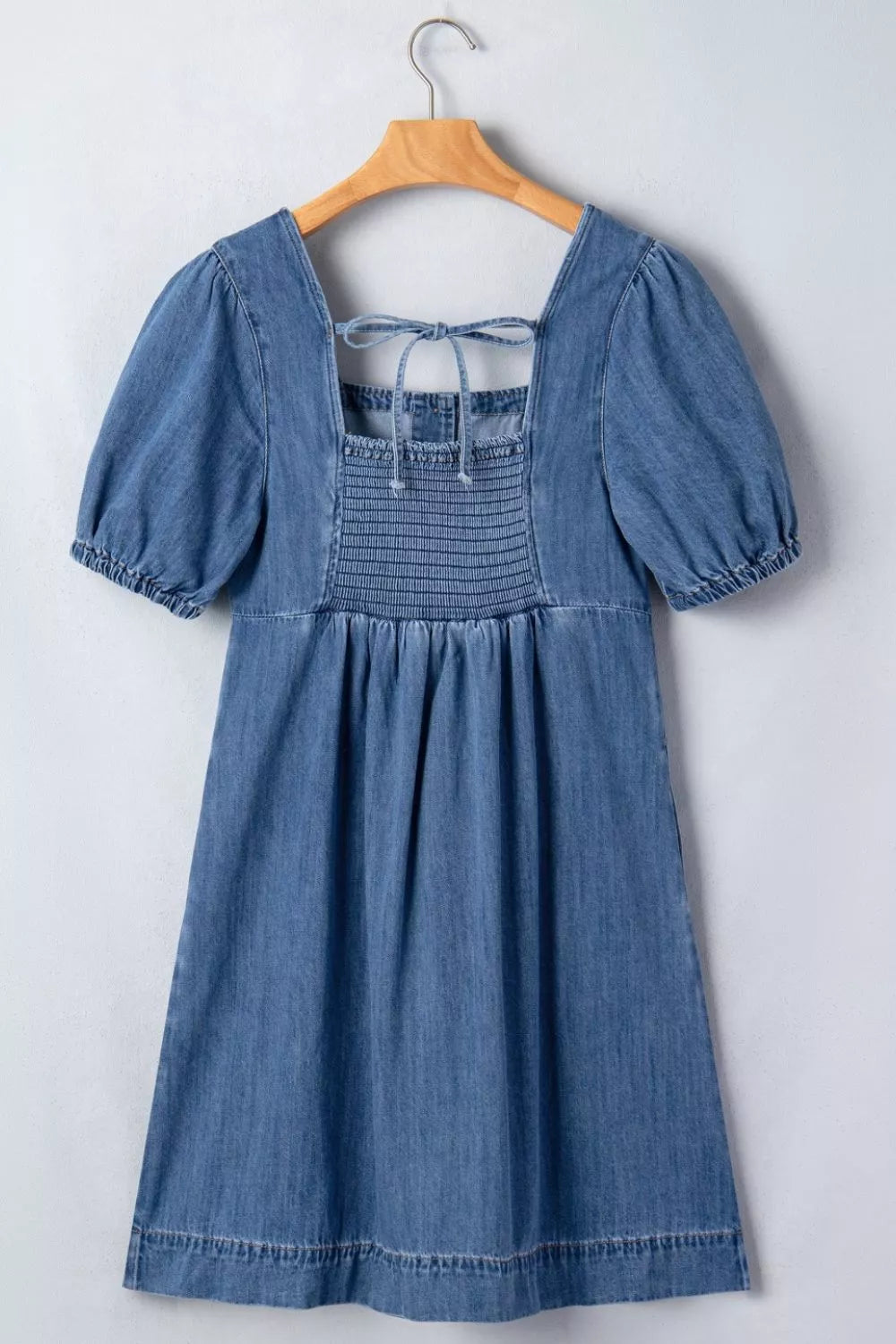 Medium wash button front puff sleeve denim dress, on model