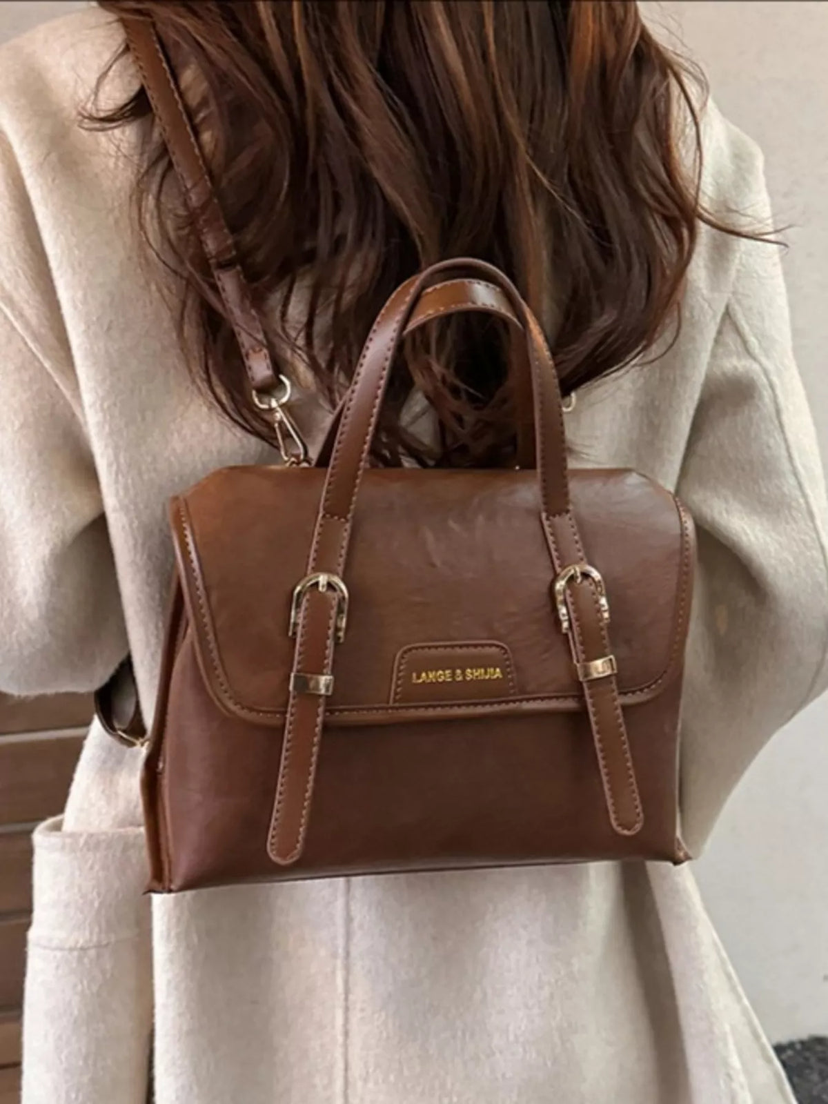 Mini leather backpack held in hand