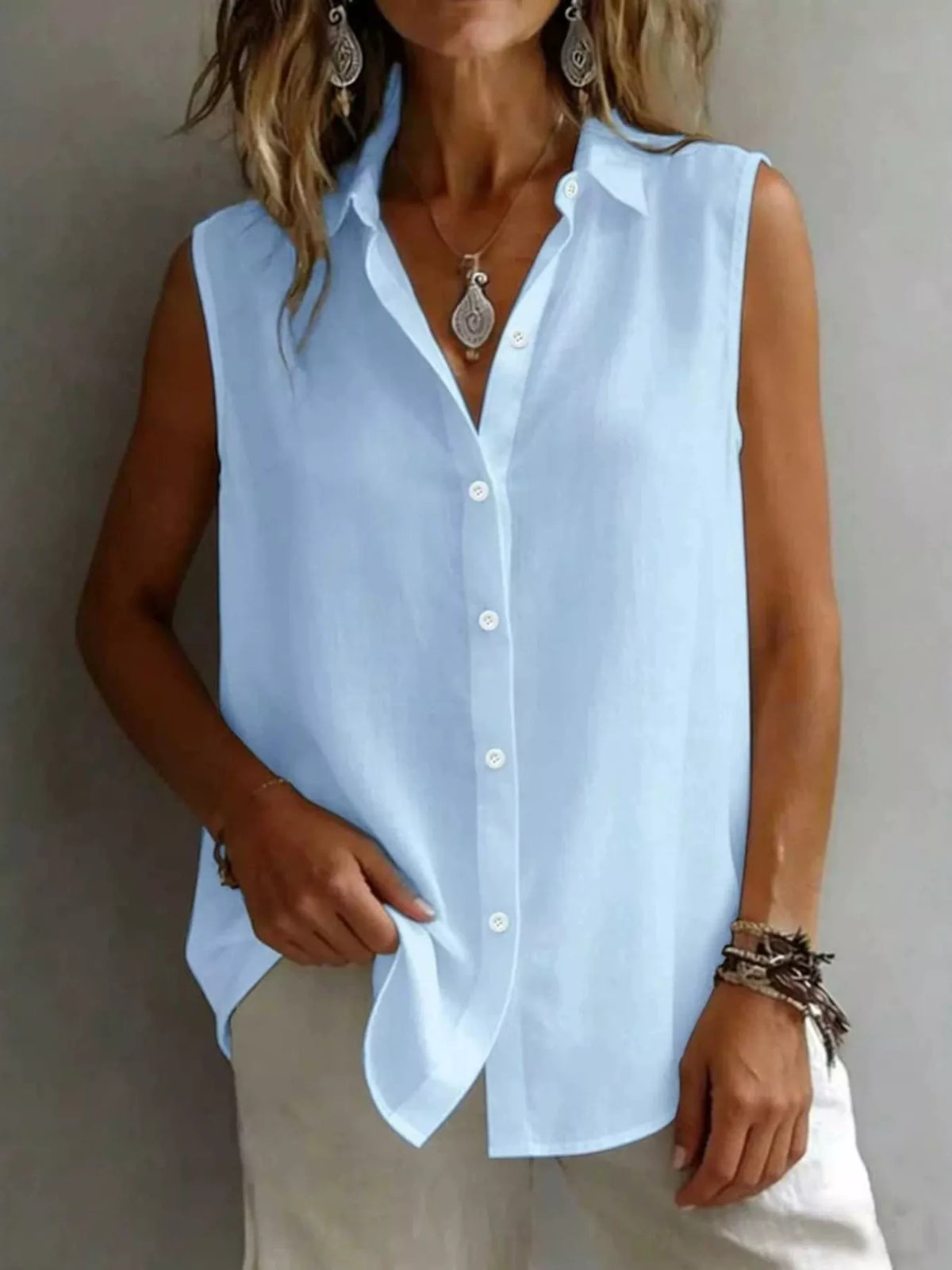 Sleeveless collared button down shirt detail view