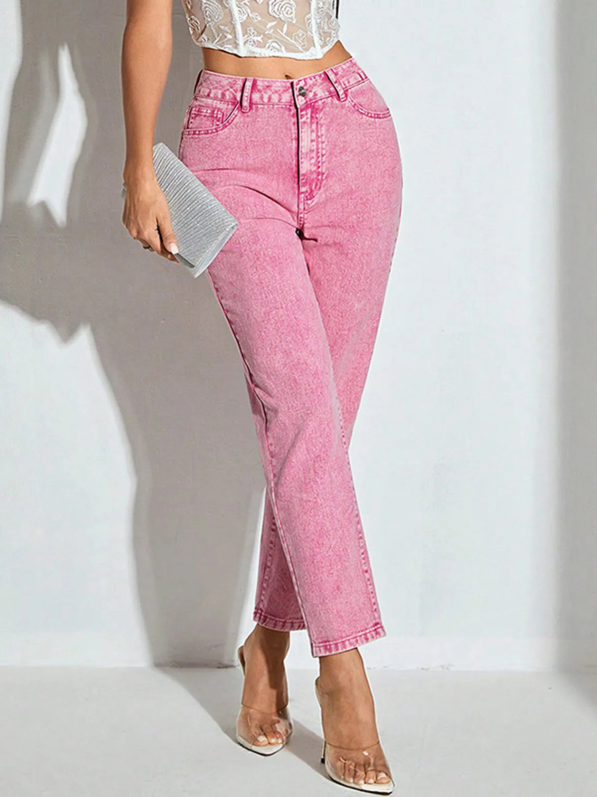 Side view of high waisted dusty pink jeans