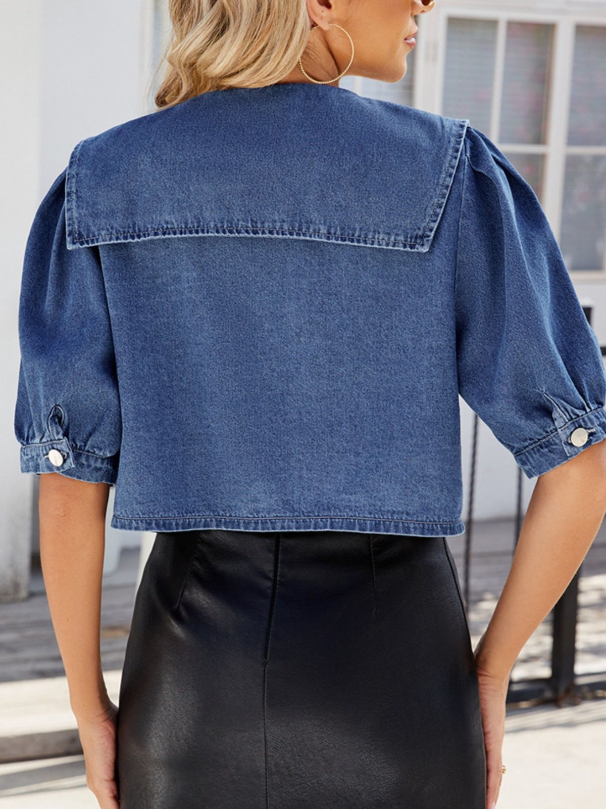 Puff sleeve detail on the navy button up top