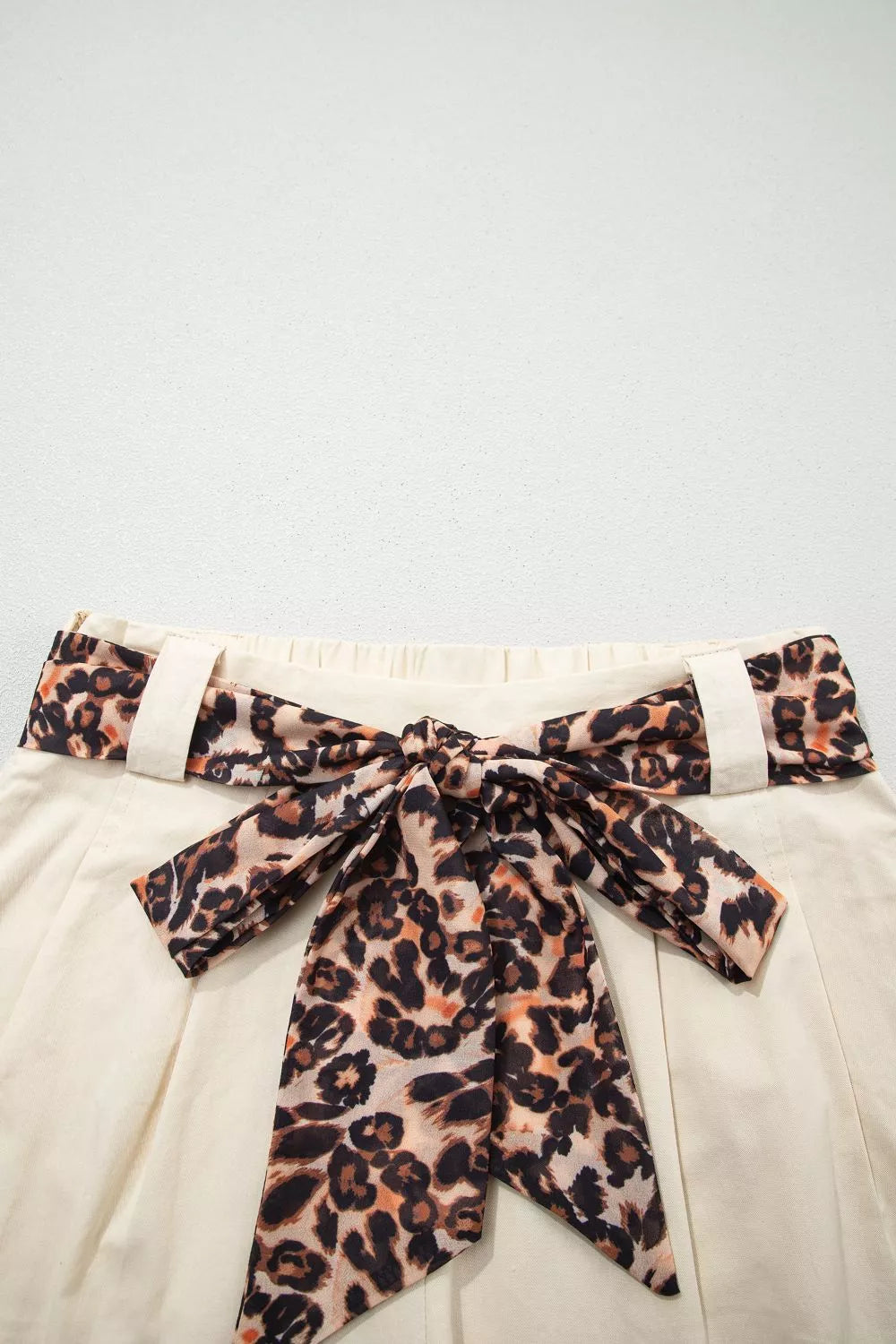 Beige high waisted pleated shorts side view