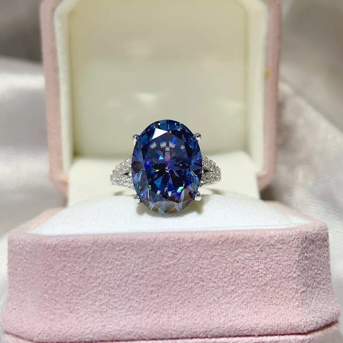 Side profile of silver setting on blue moissanite ring