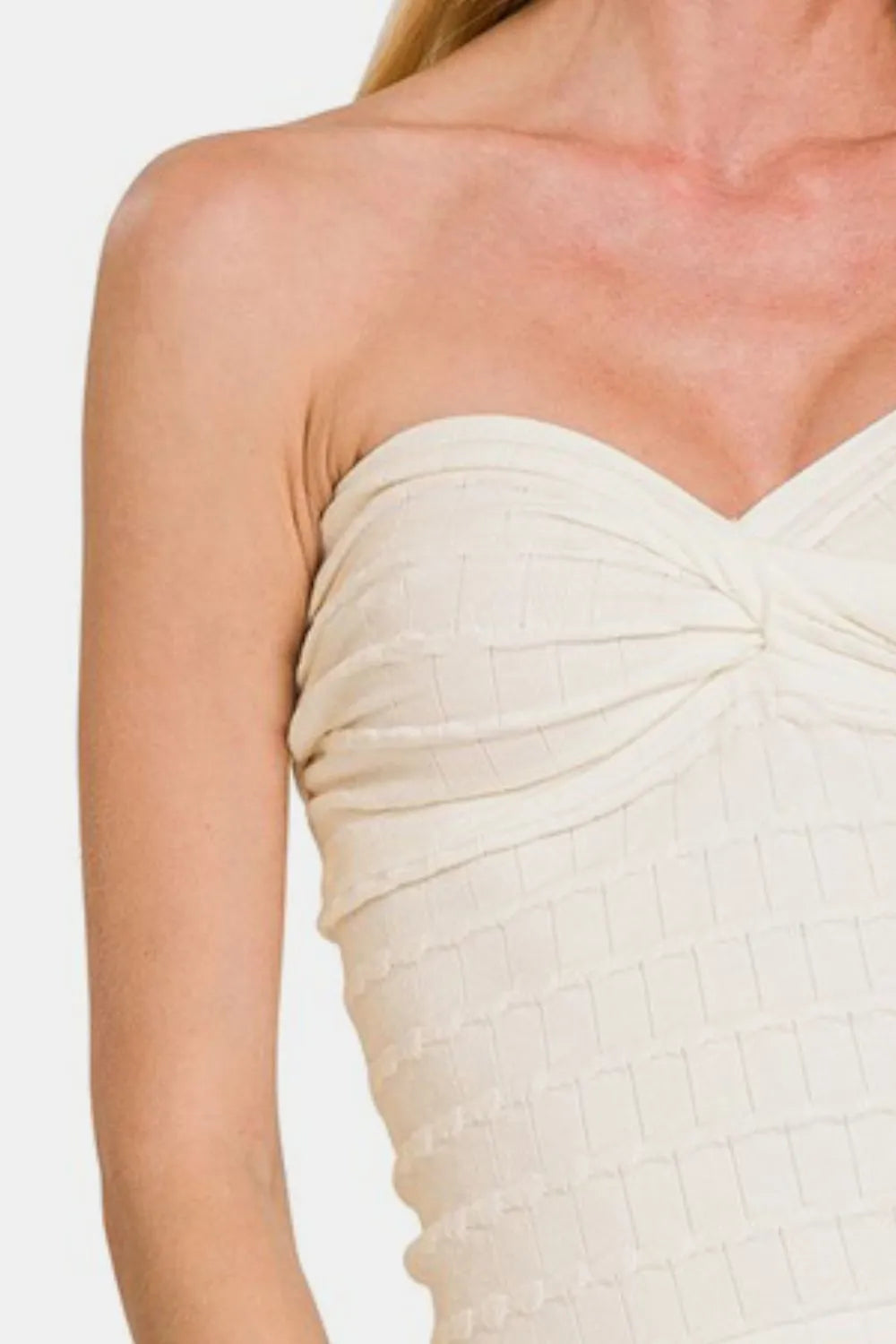 Twisted sweetheart neckline on ivory top