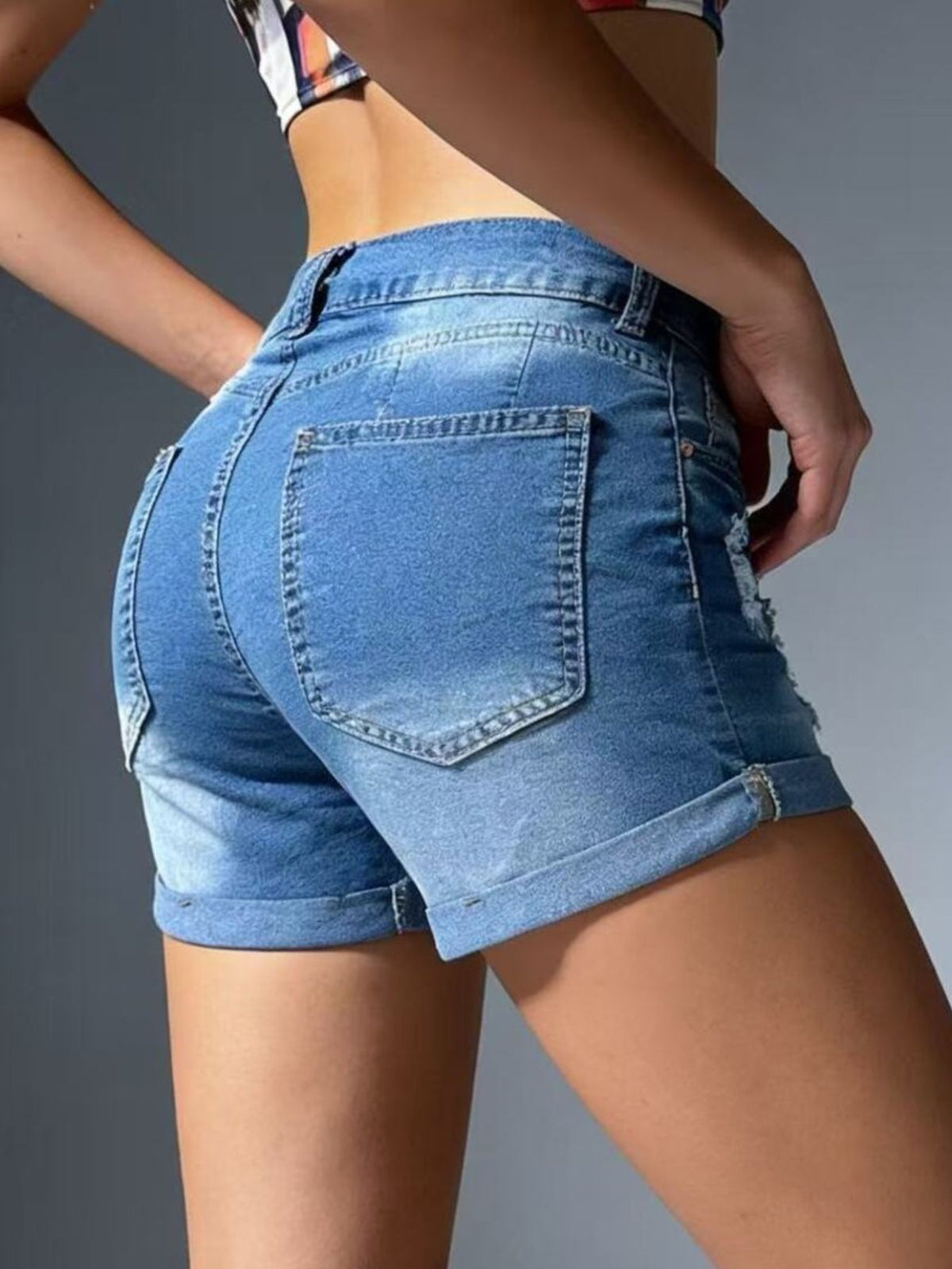 Pocket detail on distressed denim shorts