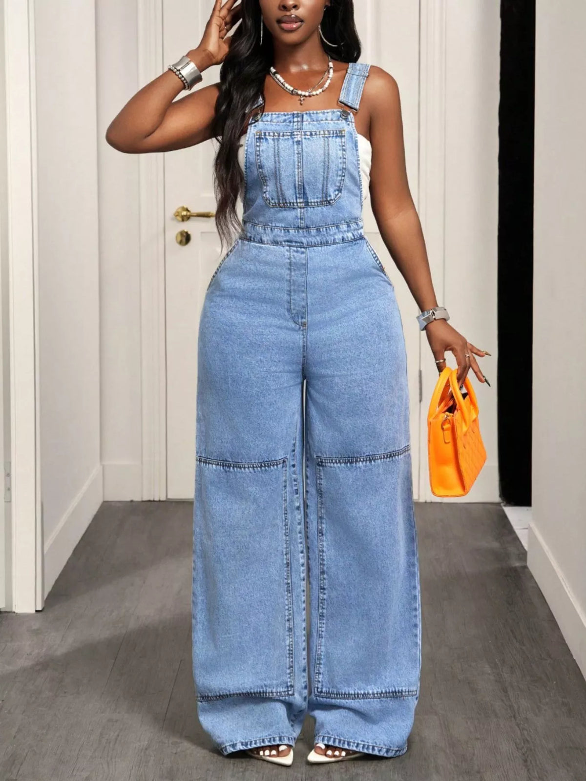 Pocket detail on blue denim overalls