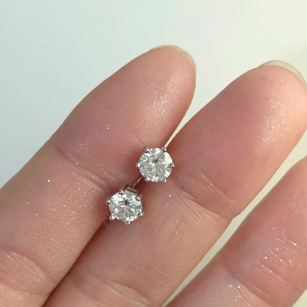 Moissanite stud earring worn on an ear