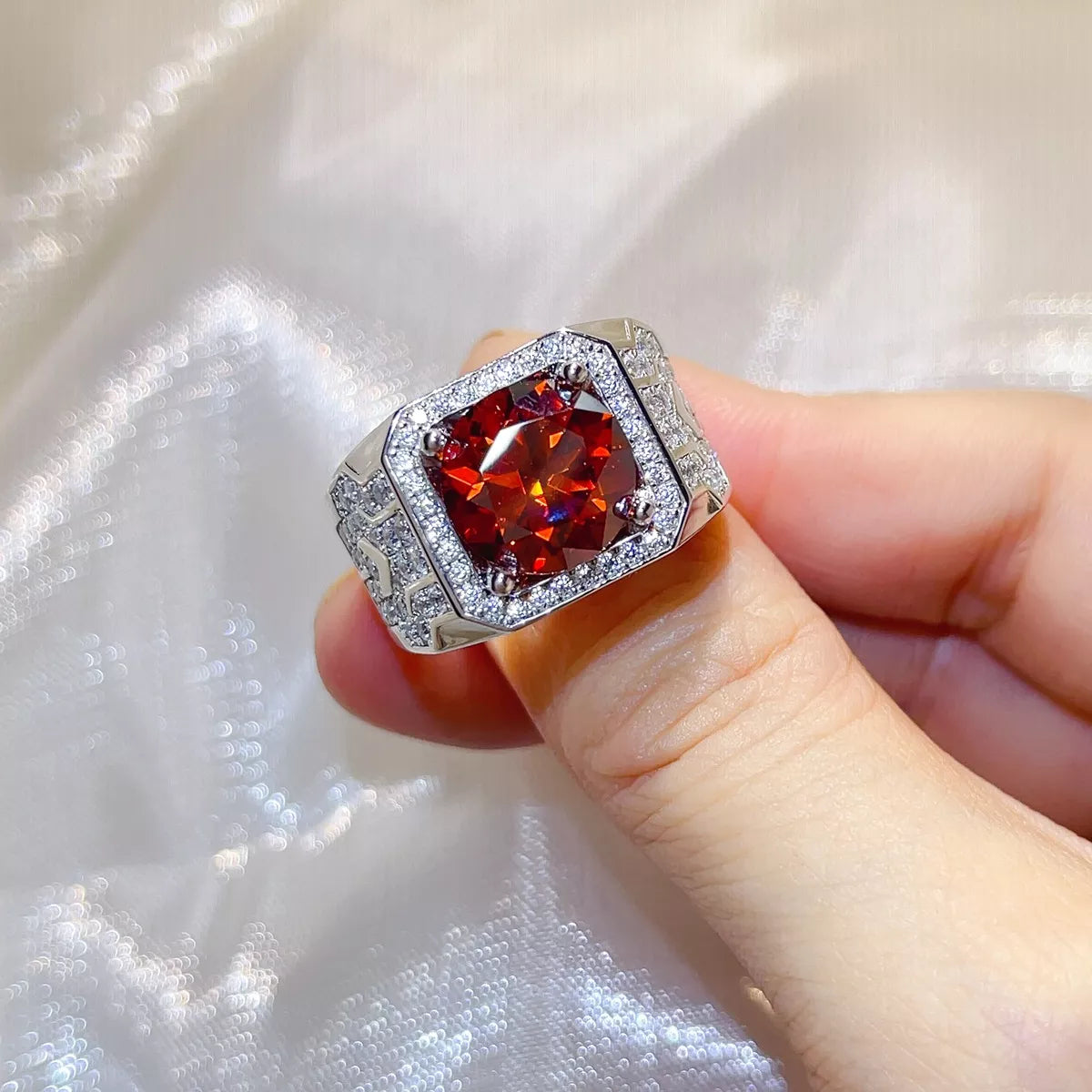 Red moissanite ring shown from the side to show the wide detailed band